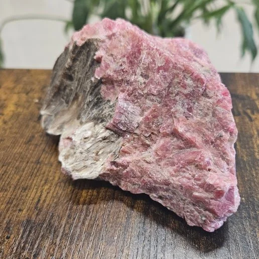 Pink rhodonite stone with black veining used for heart healing and emotional grounding.