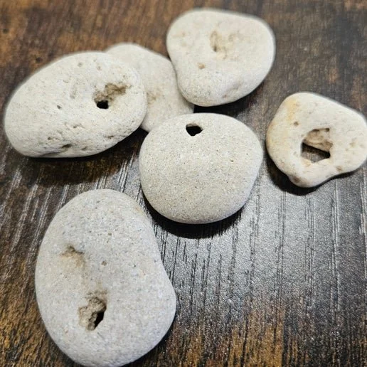 Natural hag stone with a naturally formed hole used as a protective talisman