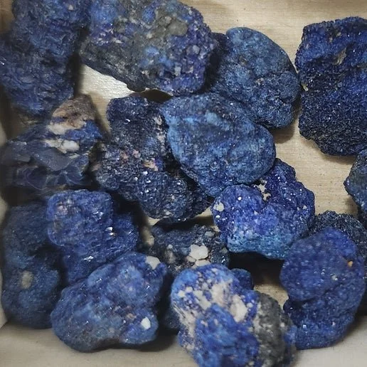 A deep blue Azurite crystal with rich, vibrant striations and a polished surface.