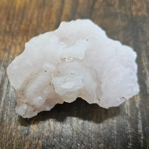 Soft pink chalcedony stone in rough and polished forms with smooth, delicate colouring.