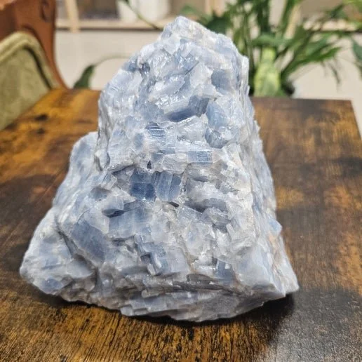 A pale blue Blue Calcite crystal with a soft, matte surface and gentle, cloudy translucency.