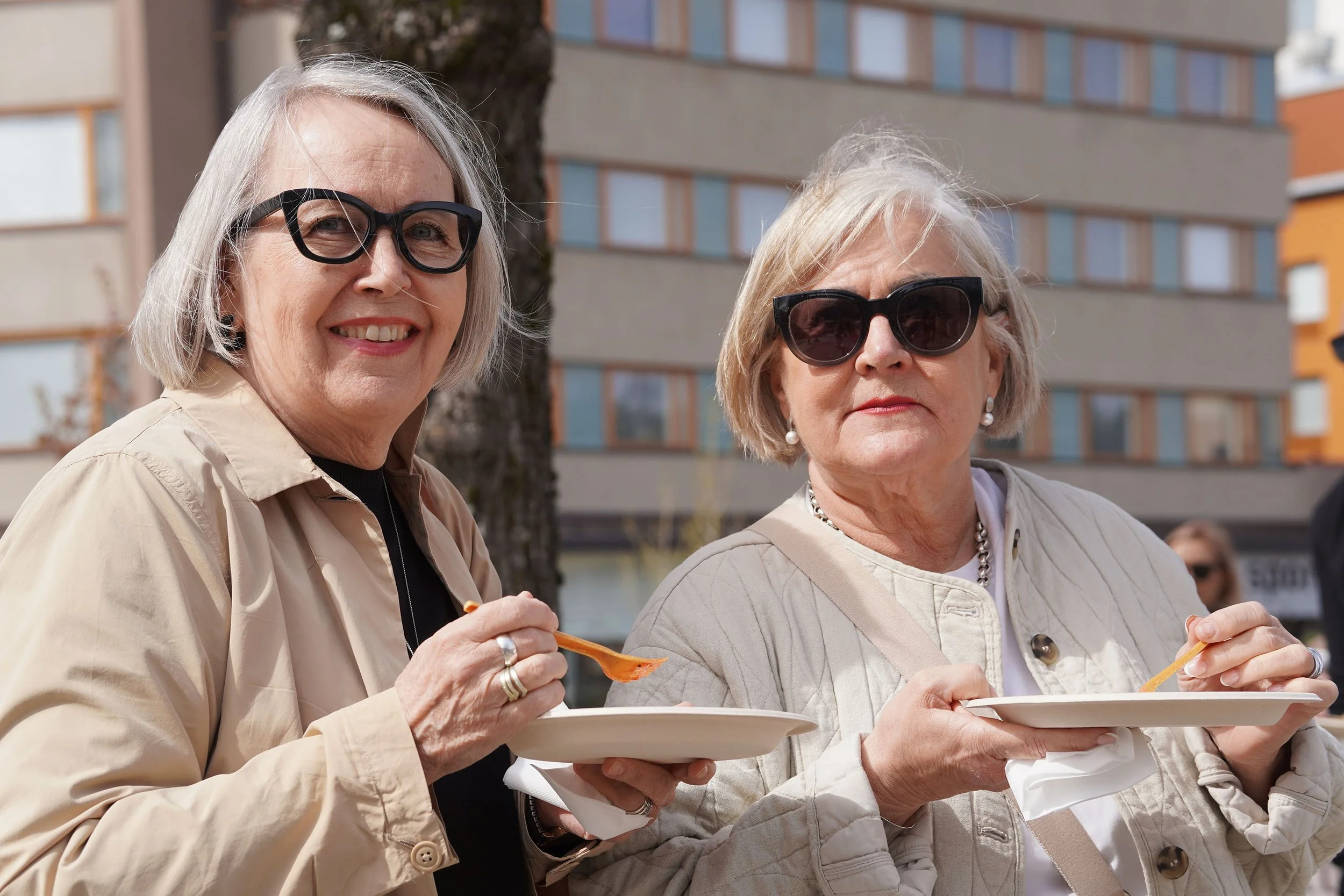 Two visitors enjoying pancakes and the atmosphere during the spring celebration.