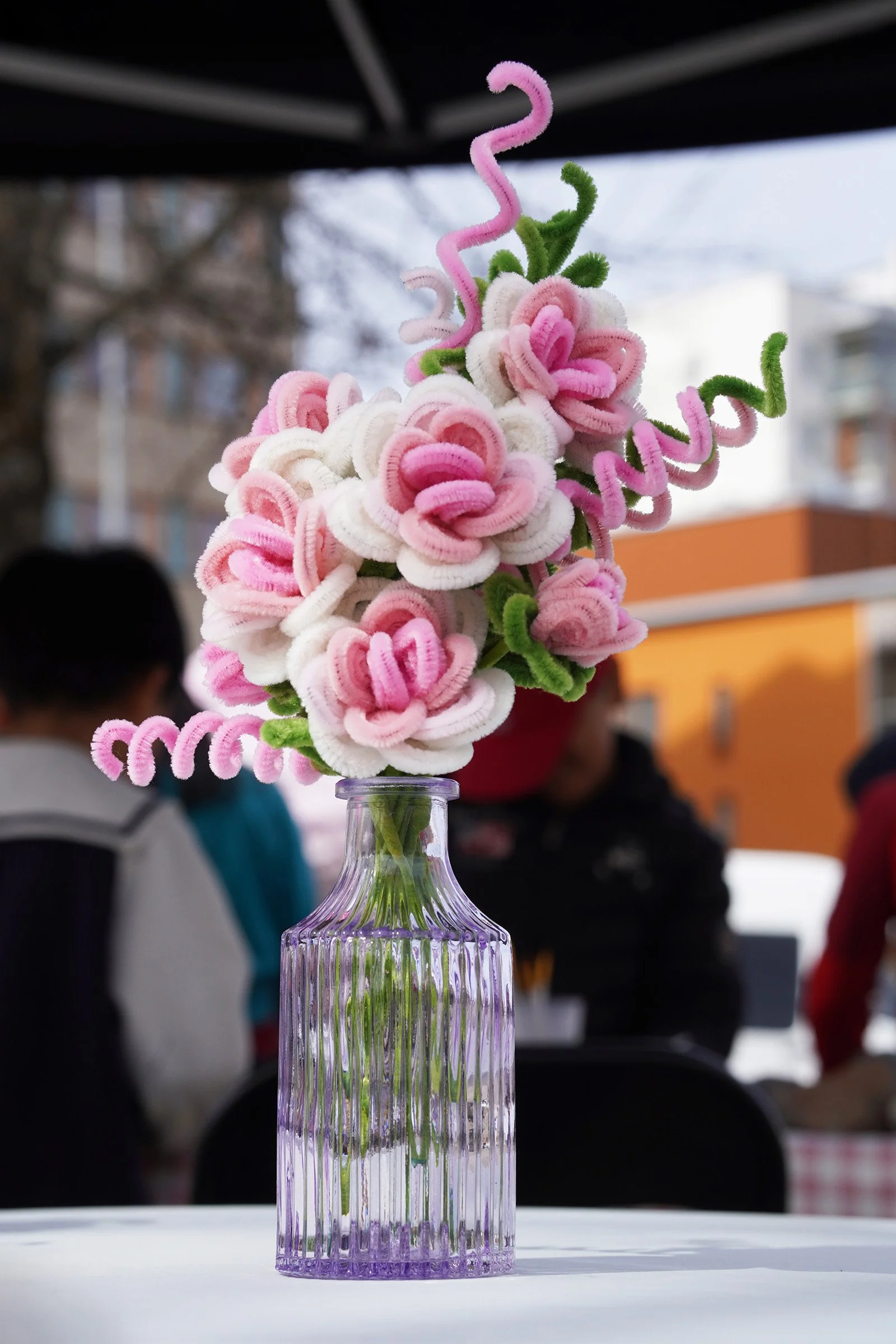 A close-up detail of handmade flowers displayed at the event.