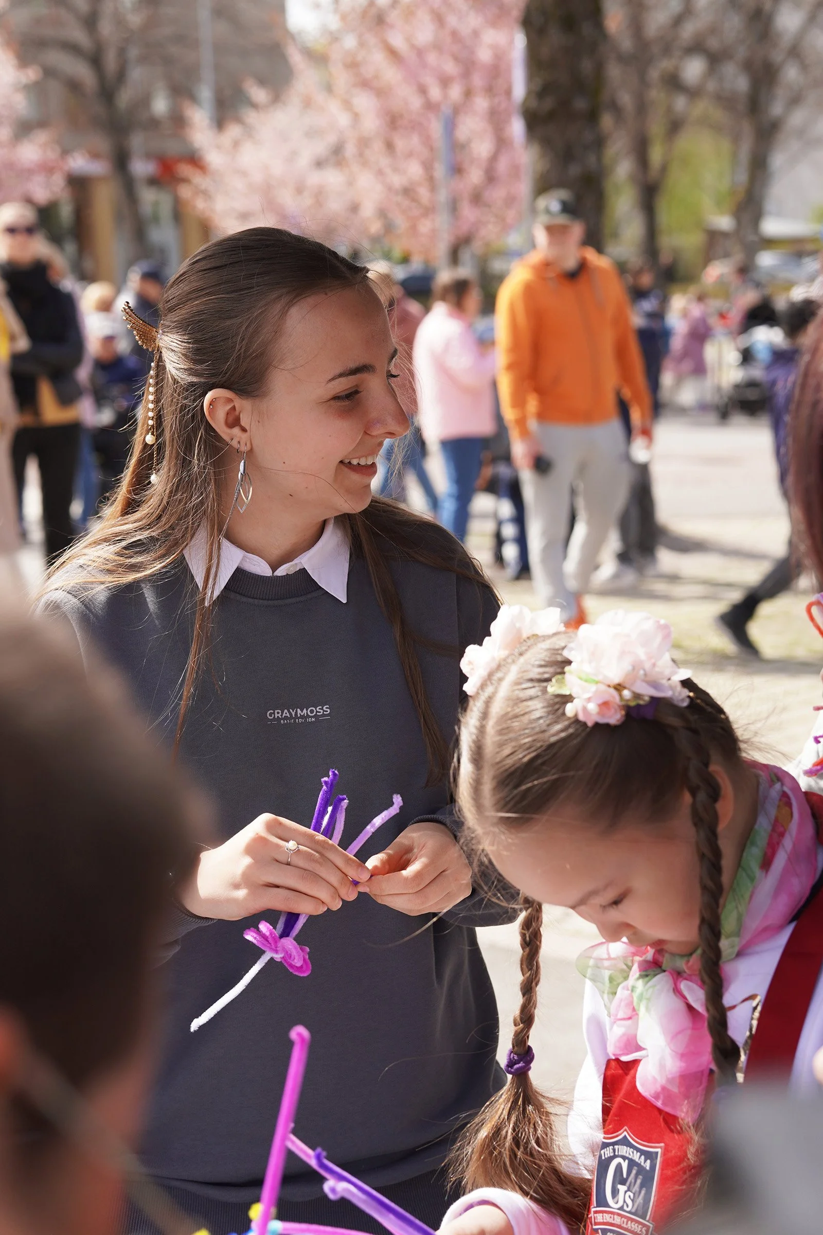 Participants creating colorful handmade flowers during an interactive activity.