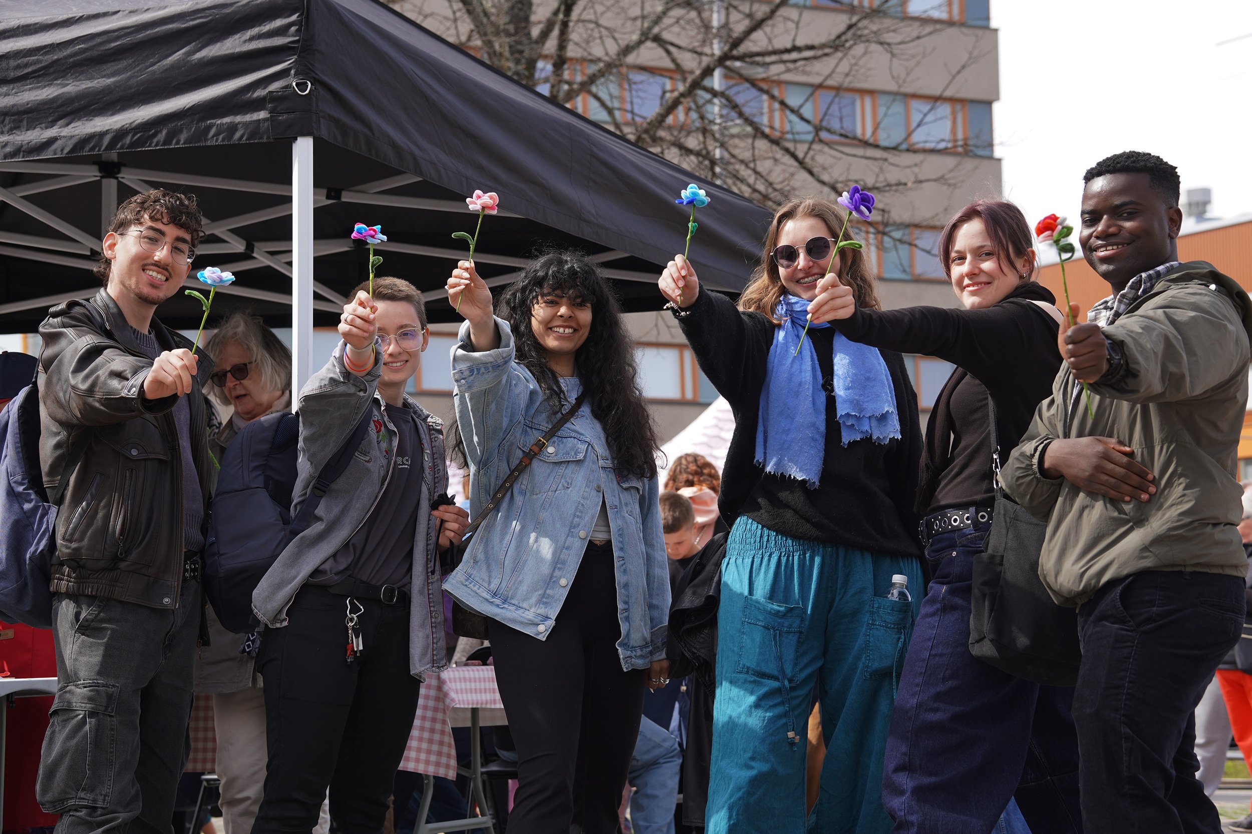 Visitors posing with their handmade flowers during the cherry blossom festival.