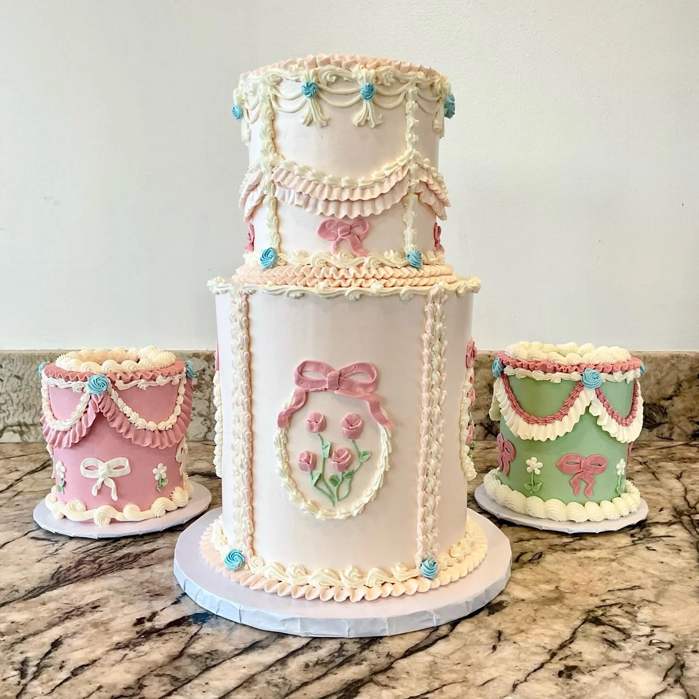 Vintage-style piped buttercream cakes in pink, white and green