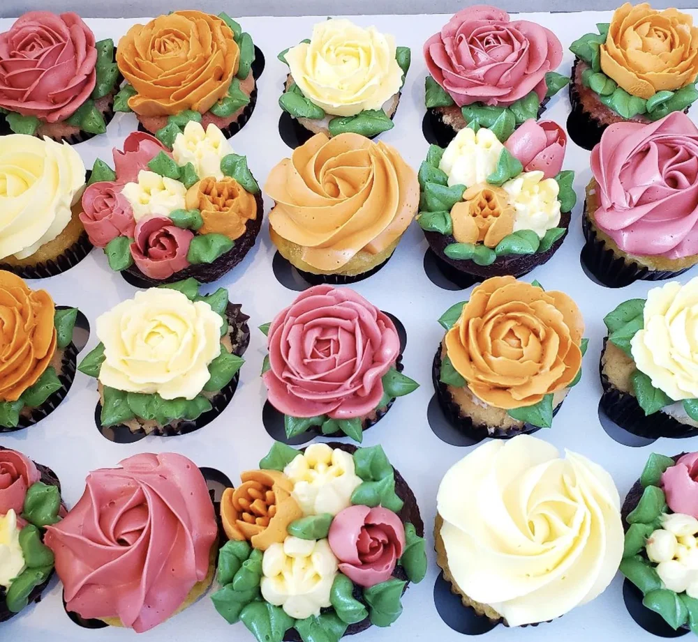 Box of cupcakes piped with buttercream roses