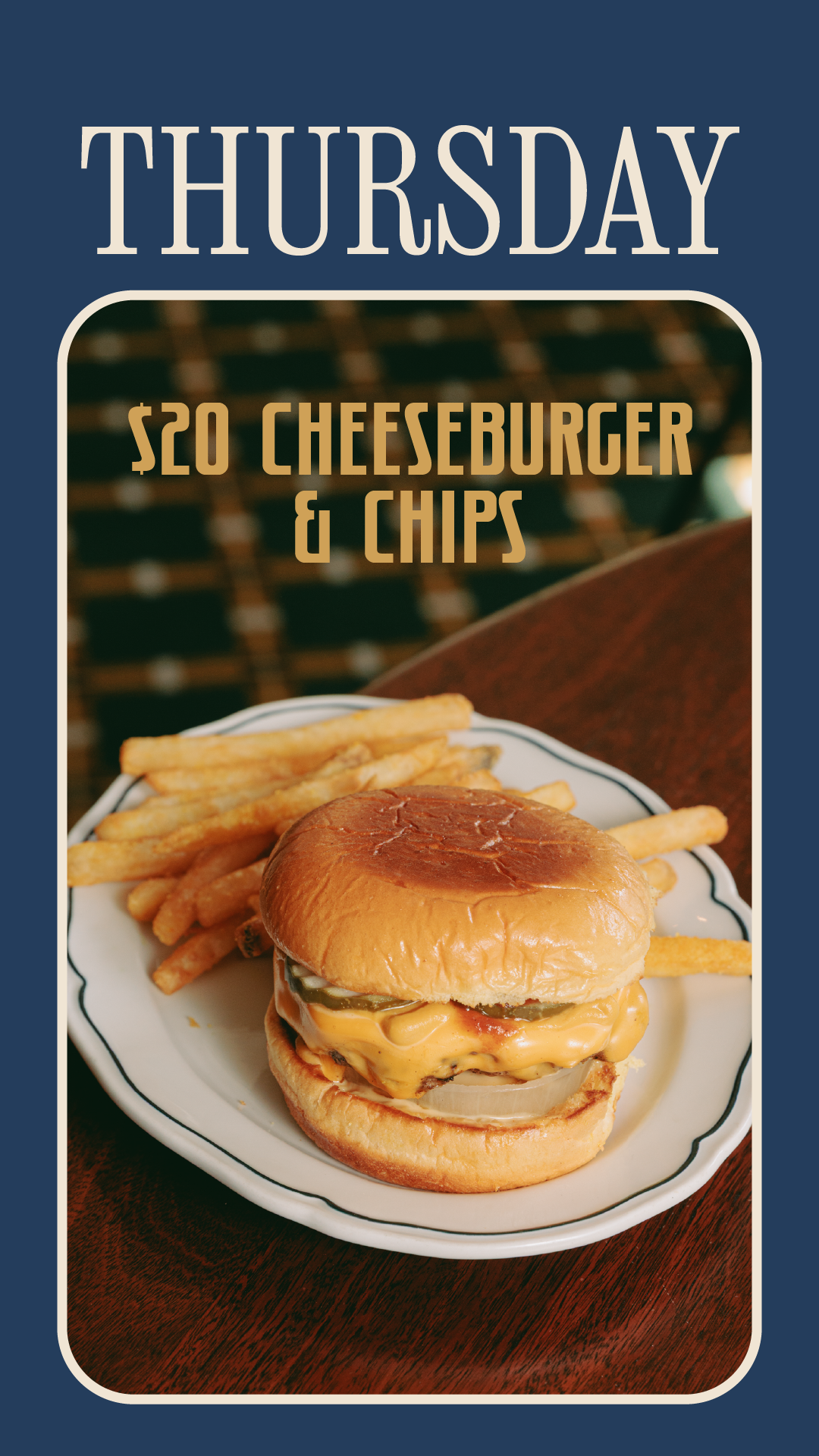 A cheeseburger and fries on a white plate, with a bun, melted cheese, pickles, onions, and ketchup, served with a side of French fries.