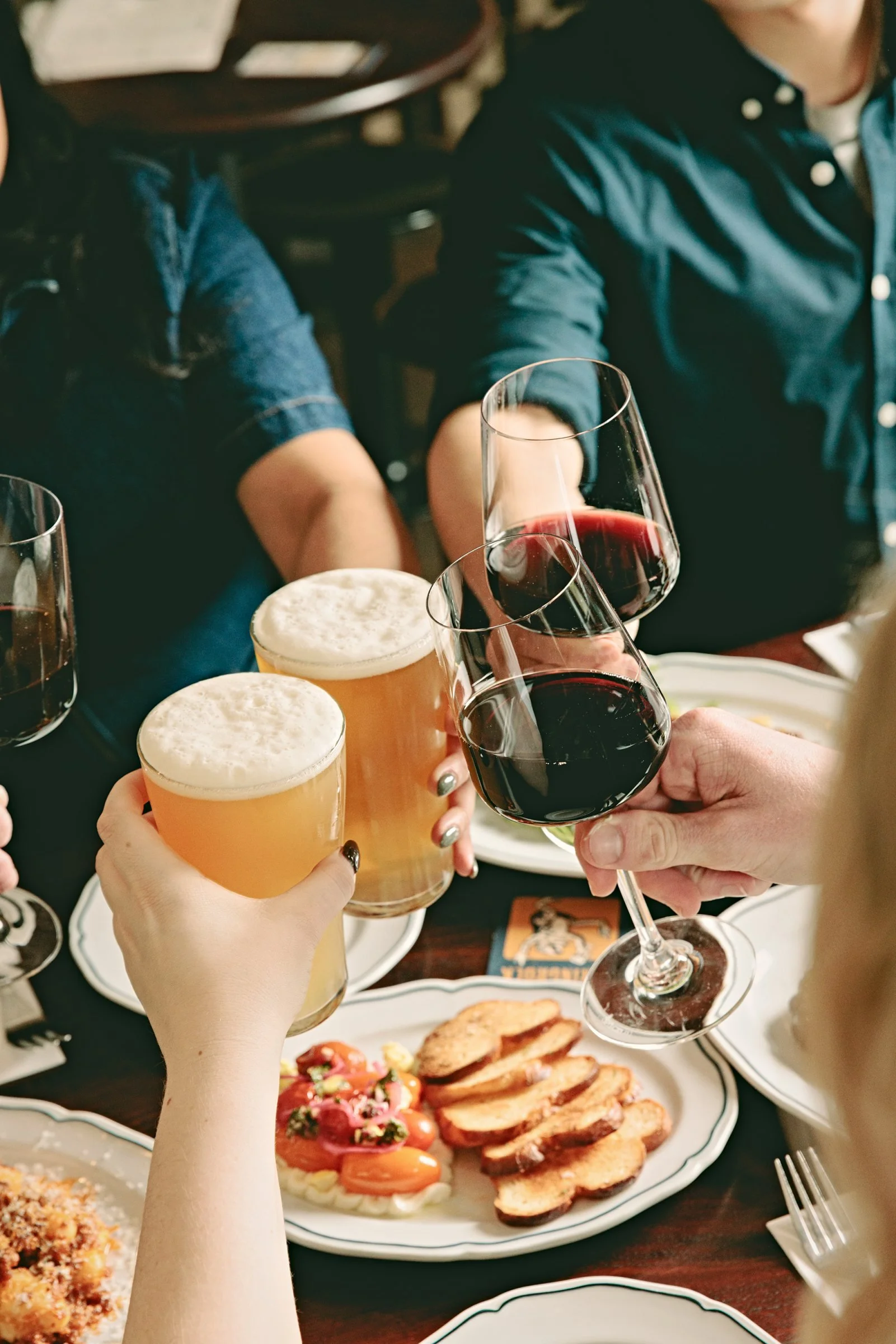 A group raising pints and wine in a big birthday cheers at Springrock