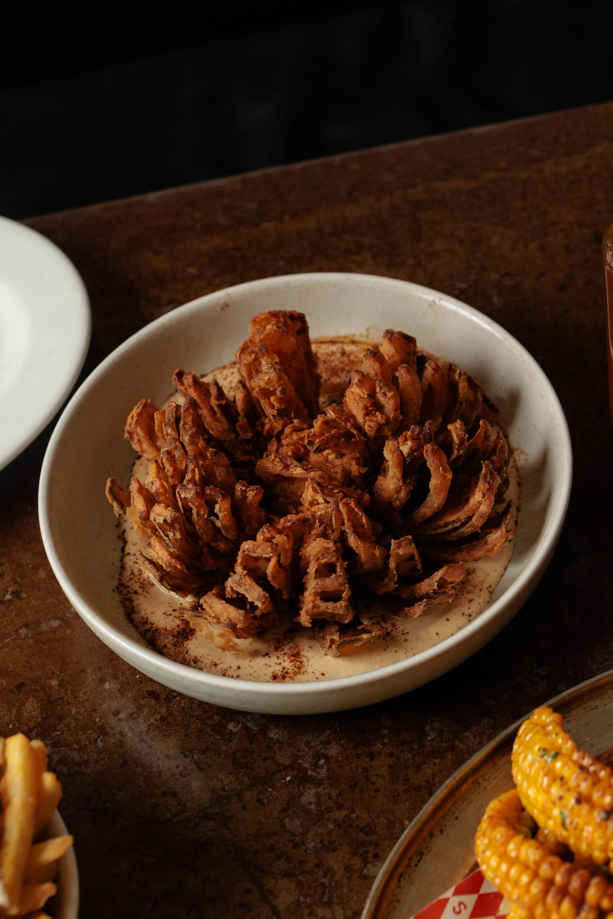 Blooming onion with smoked French onion dip and grilled corn