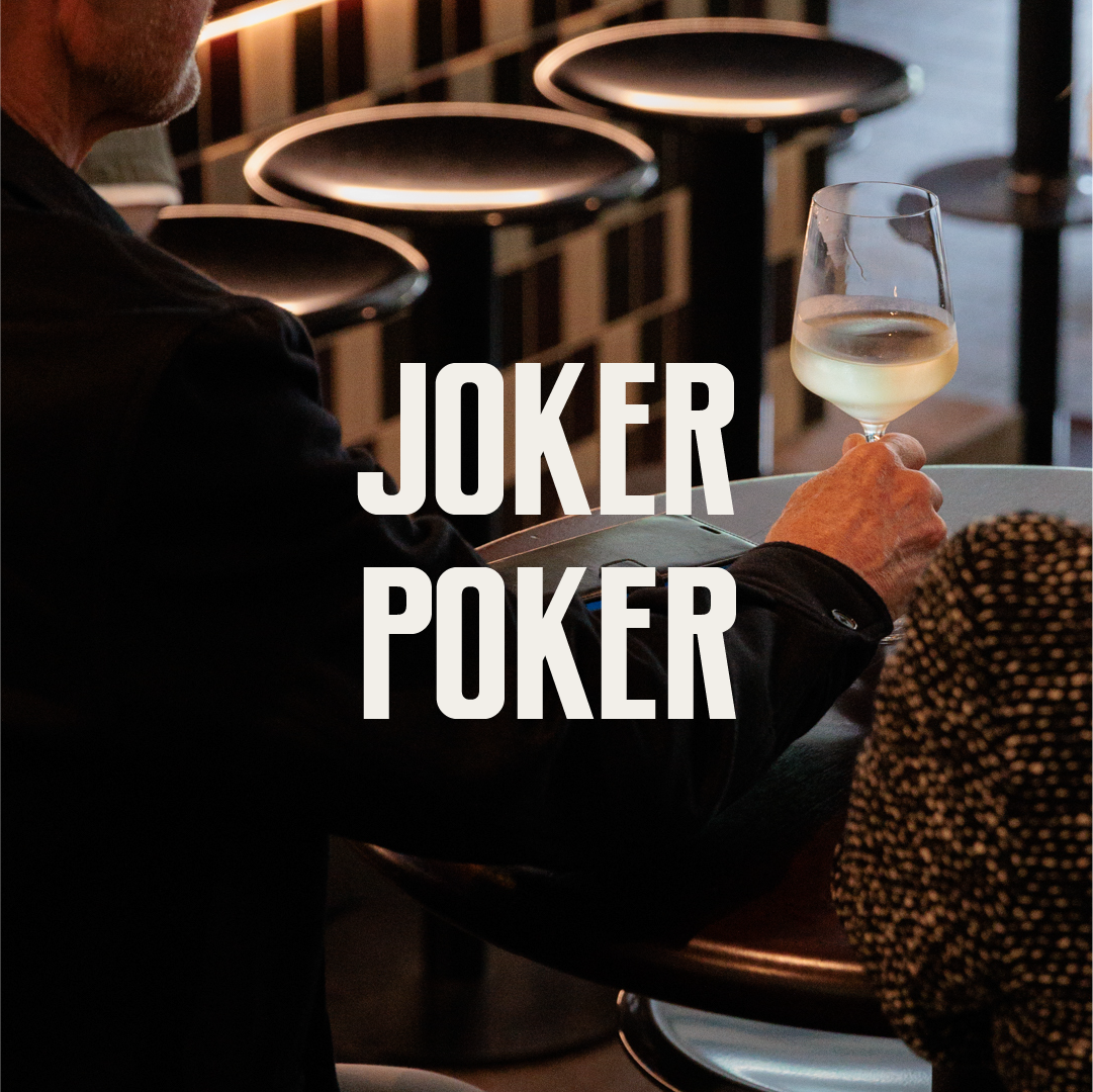Person holding a glass of white wine at a bar or restaurant, with the words "JOKER POKER" overlaid.