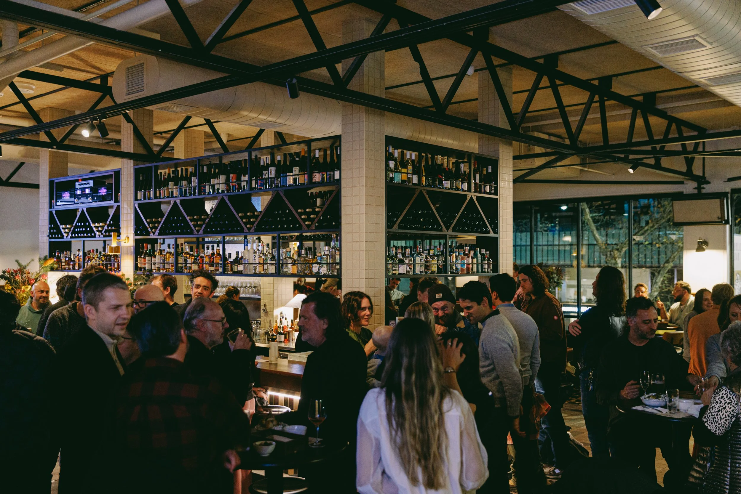 Guests mingling and laughing around the busy Springrock bar