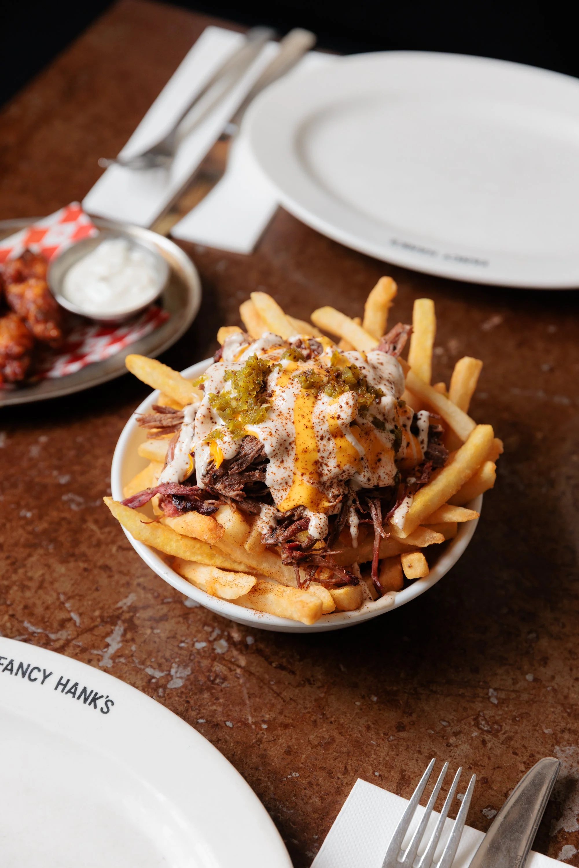 Loaded fries topped with pulled beef brisket, cheese and chimichurri mayo