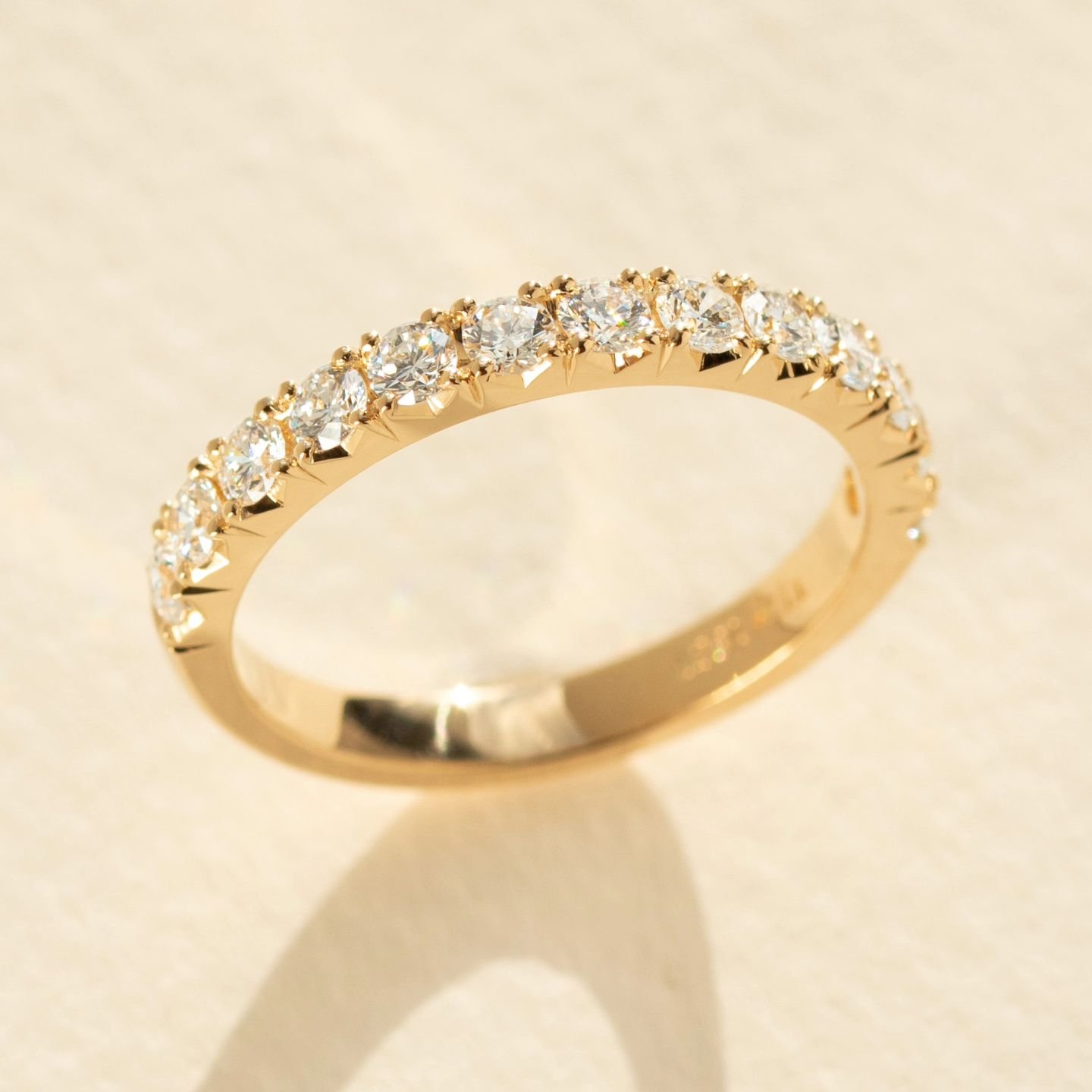 A classic claw-set diamond wedding ring with an added touch of difference. Introducing our TRM Signature V-cut, an engraved detail on the side of each setting that adds to the sparkling array of each set diamond, creating a spectacular result!