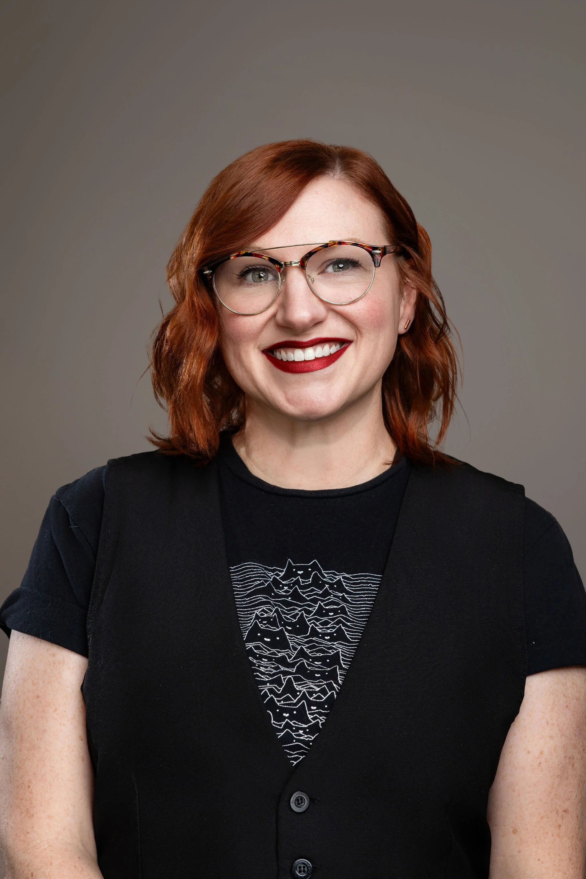 Li Ho, licensed esthetician at The Collective Salon & Med Spa, standing in a cozy treatment room with plants, skincare products, and a professional facial setup