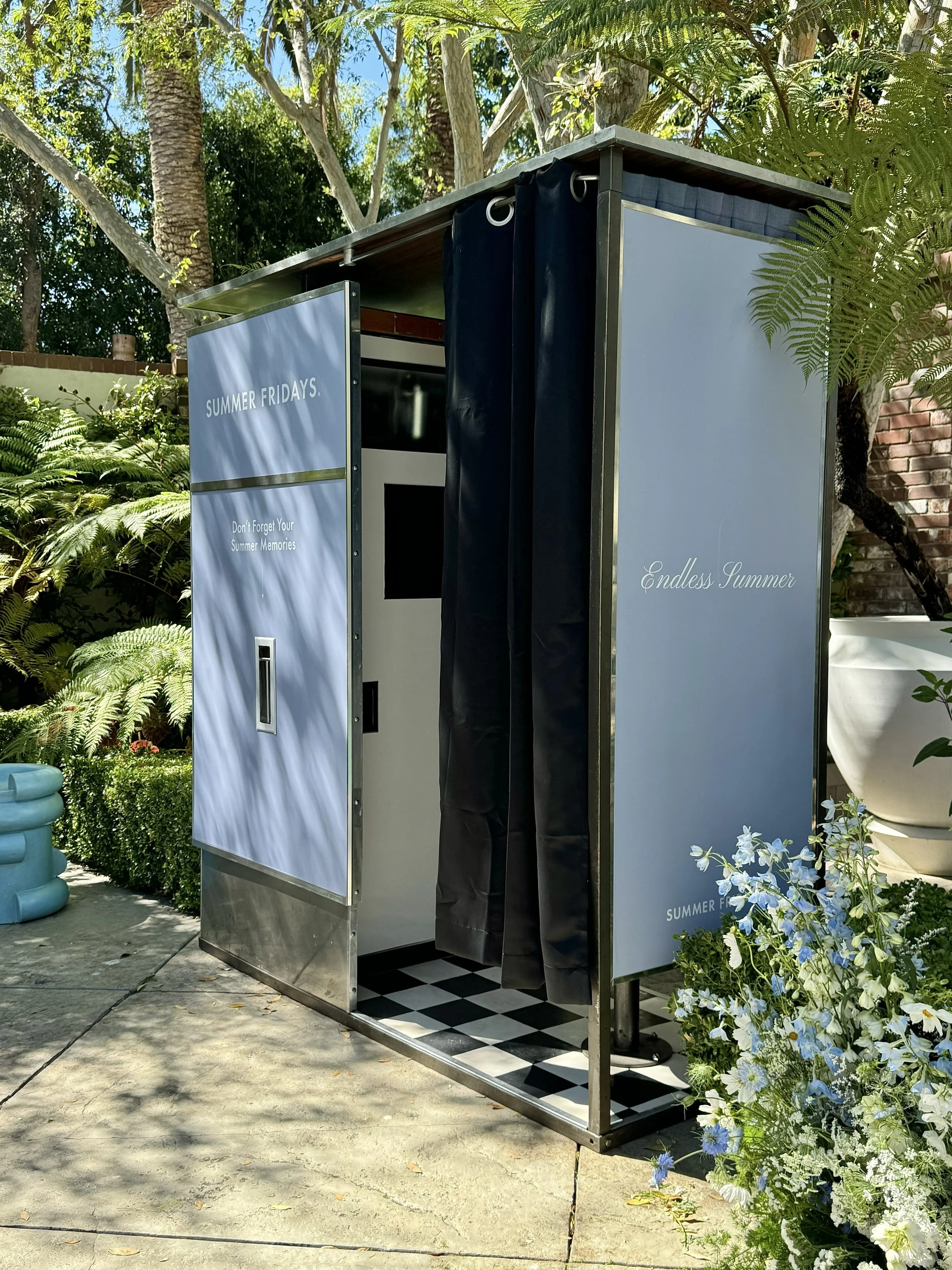 A Model 14 vintage analog photobooth with a light blue Summer Fridays decal.
