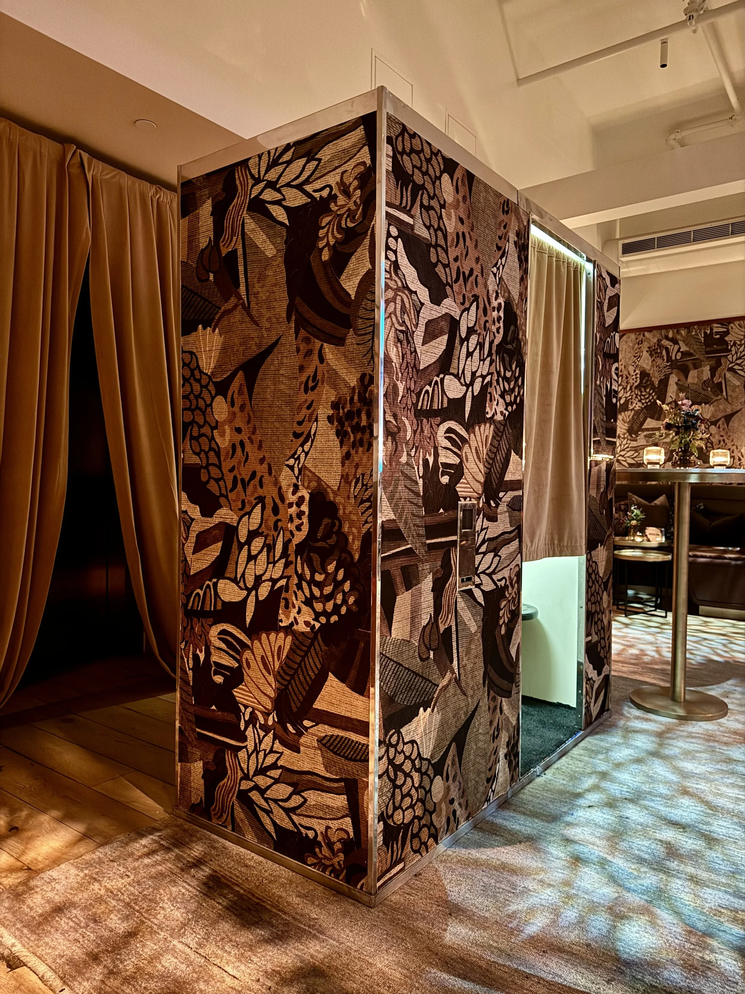 Custom wrapped vintage analog photo booth featuring detailed nature and jungle artwork artwork setup for a special celebrity event.