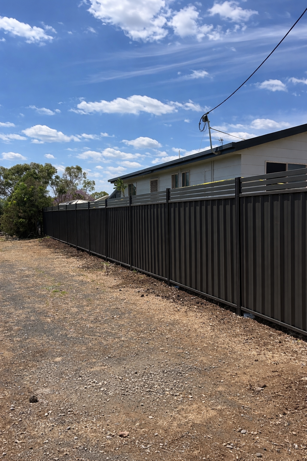 Colorbond boundary fencing along residential property