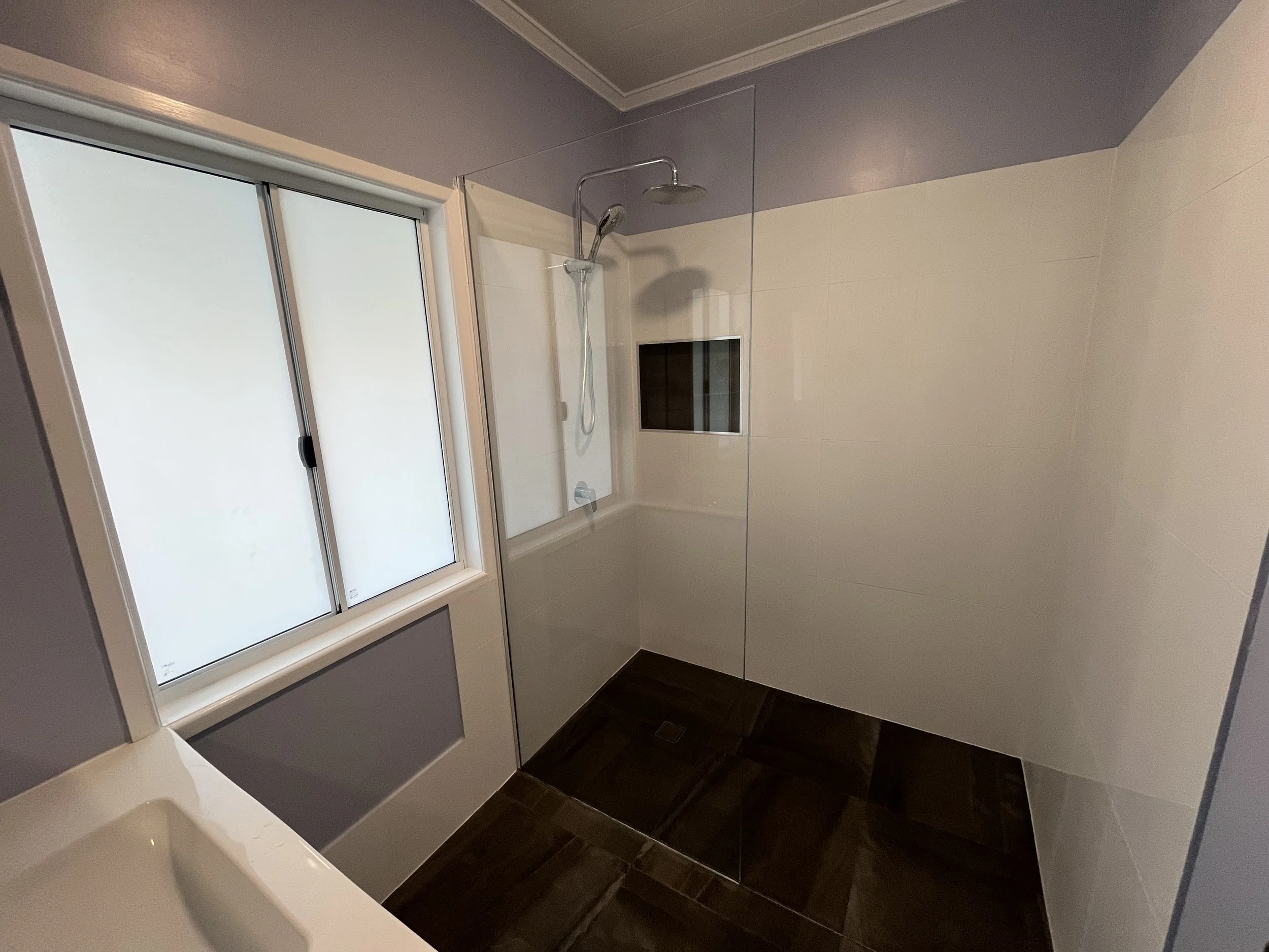 Modern bathroom renovation with shower and tiled flooring