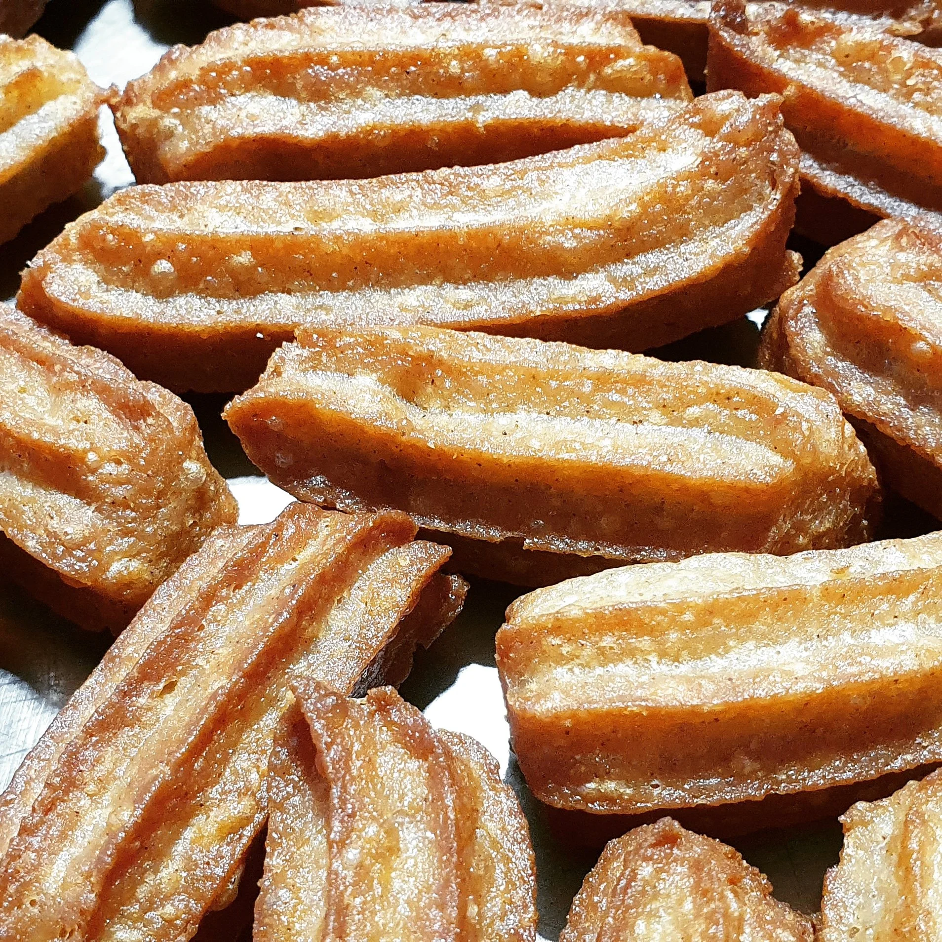 Close-up of golden-brown fried waffles dusted with powdered sugar.