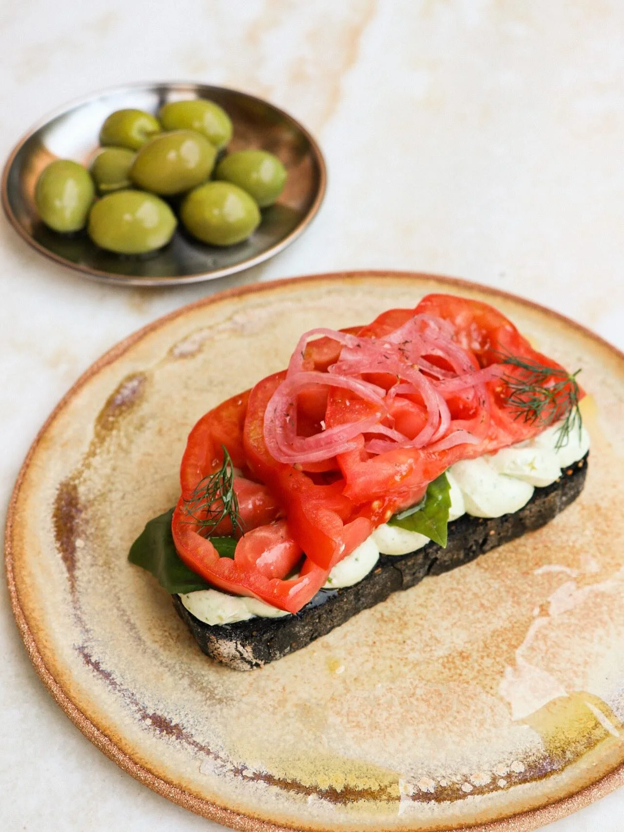 New on the menu 
Our summer toast celebrates tomatoes at their peak &mdash; layered with whipped basil ricotta, pickled onions, fresh herbs, a good drizzle of olive oil, and a sprinkle of smoked salt. Simple, seasonal, and bursting with flavor.