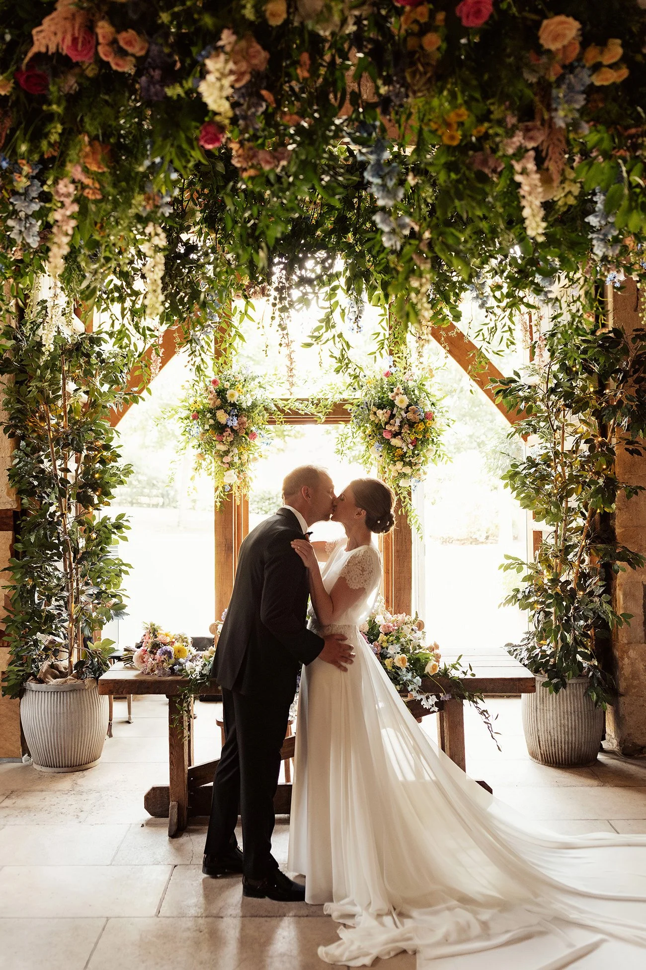 bride and groom kiss at stone barn wedding