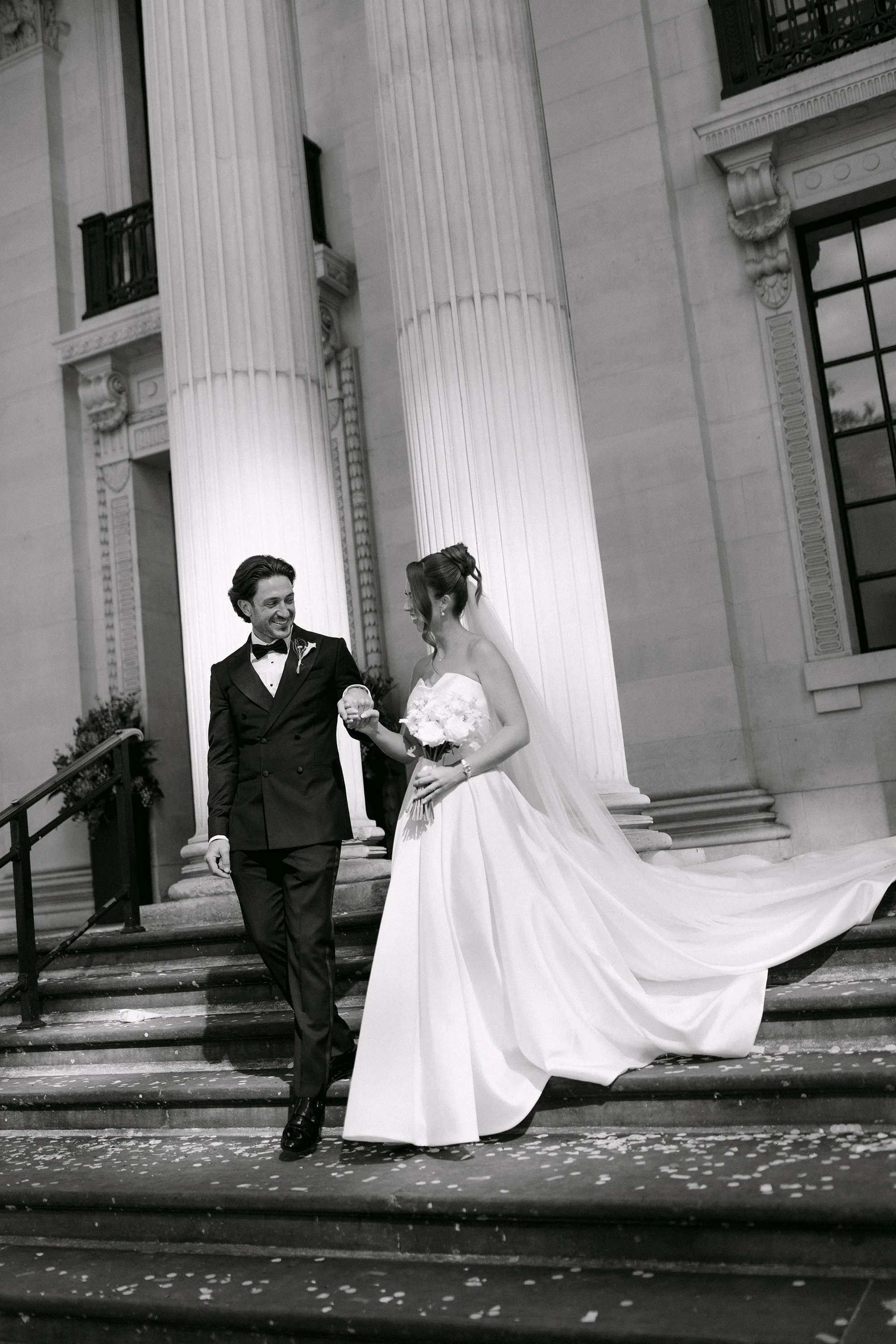bride and groom walking down steps of Marylebone town hall wedding