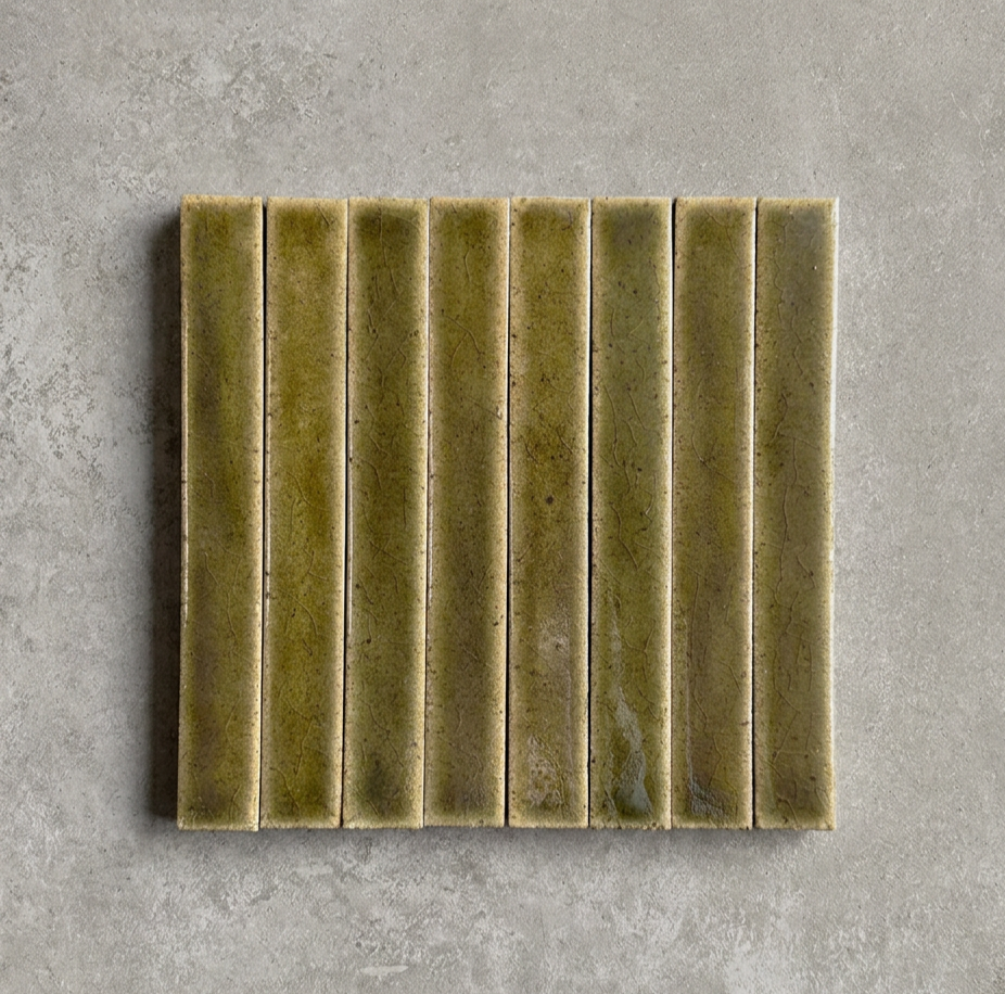 TSUKI Olive is a handcrafted Japanese ceramic wall tile with a slim profile and richly variegated glaze, bringing depth, warmth, and refined elegance to contemporary interiors.