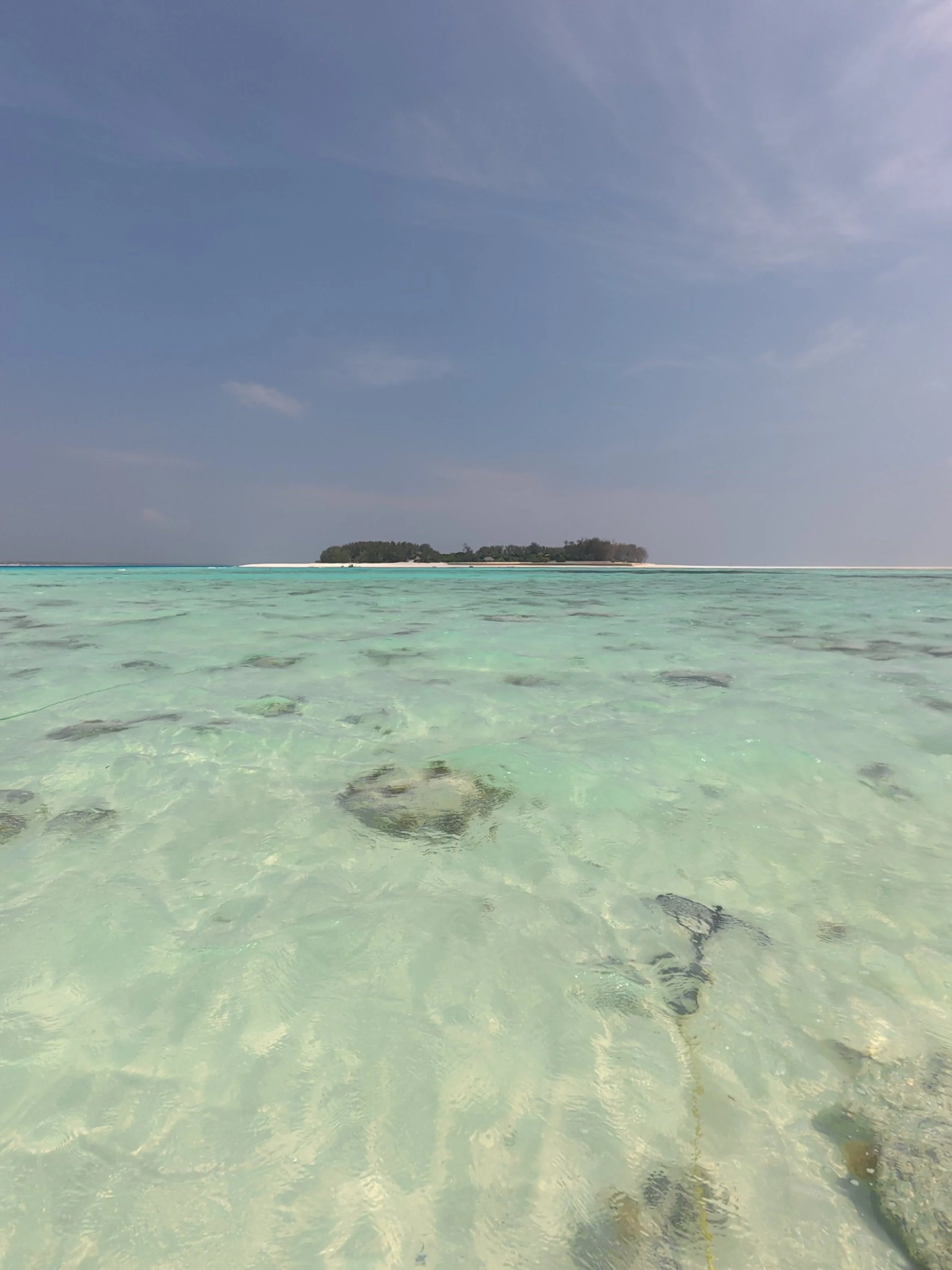 Turquoise water around Mnemba Island with boats anchored offshore