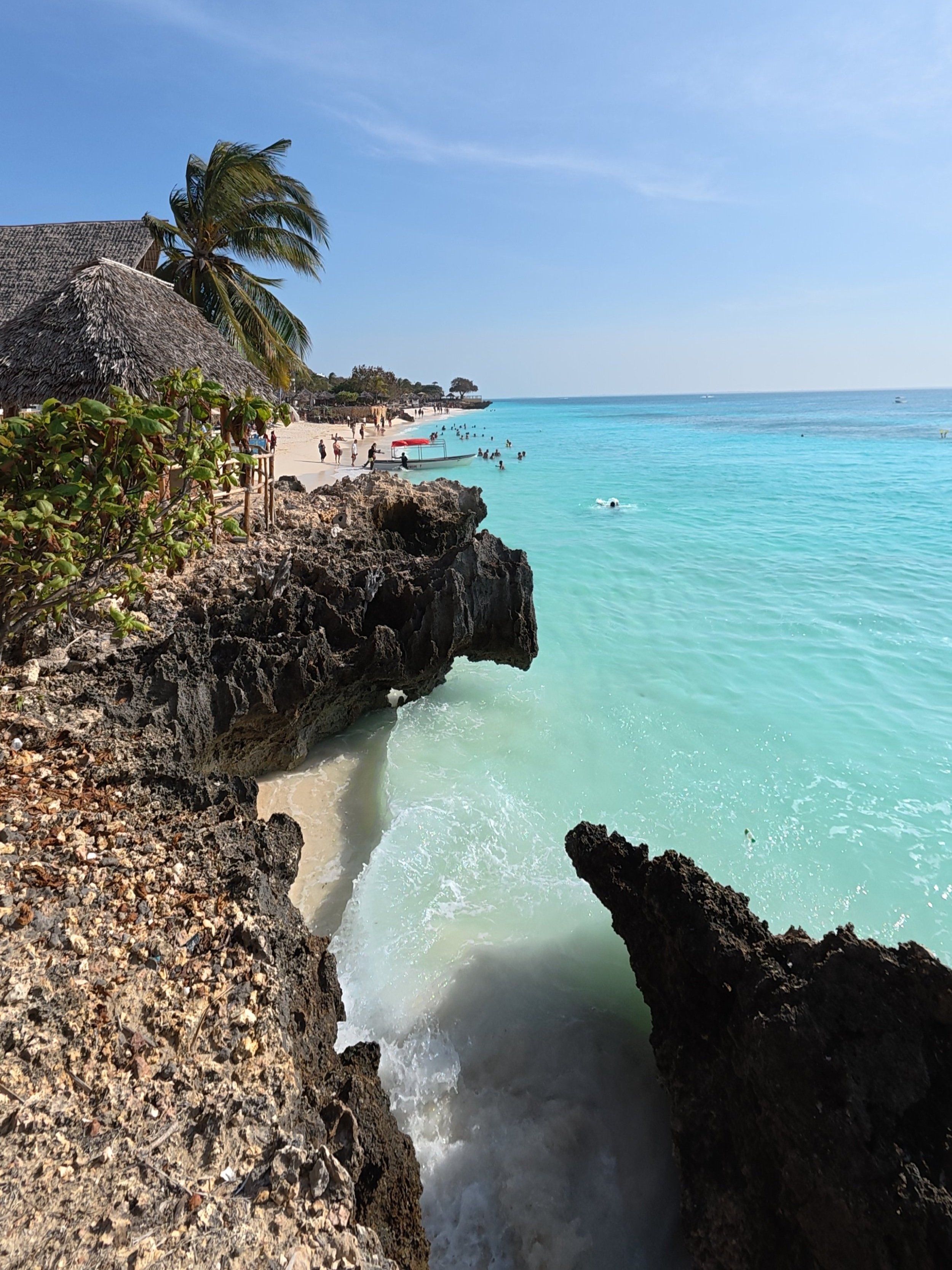 Nungwi Beach viewed through rock formations on the coast