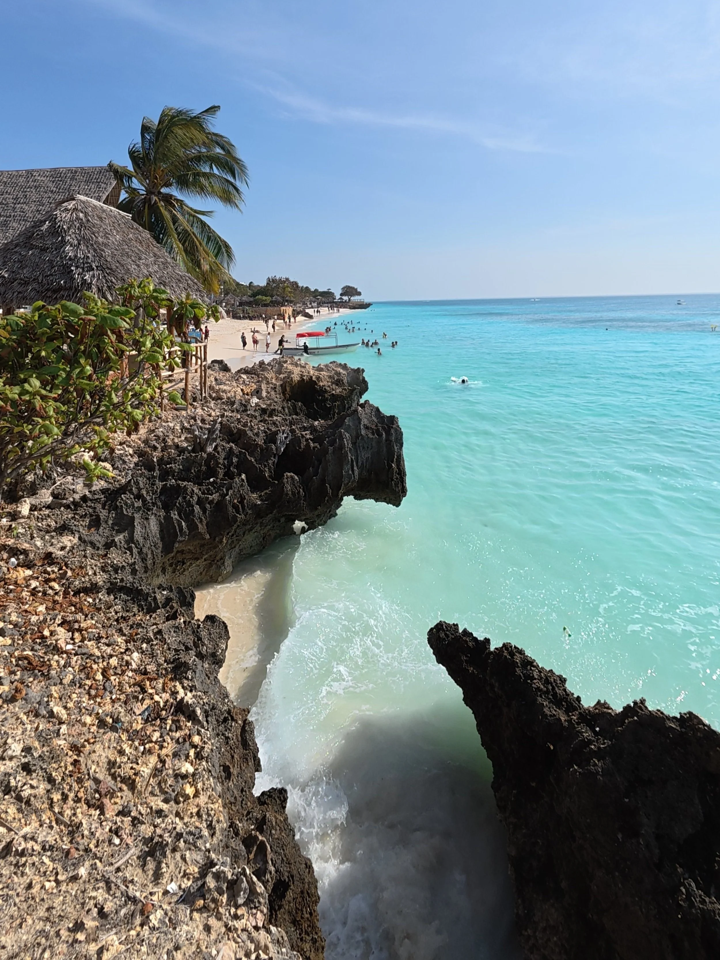 Rocky shoreline at Nungwi beach in Zanzibar with clear water