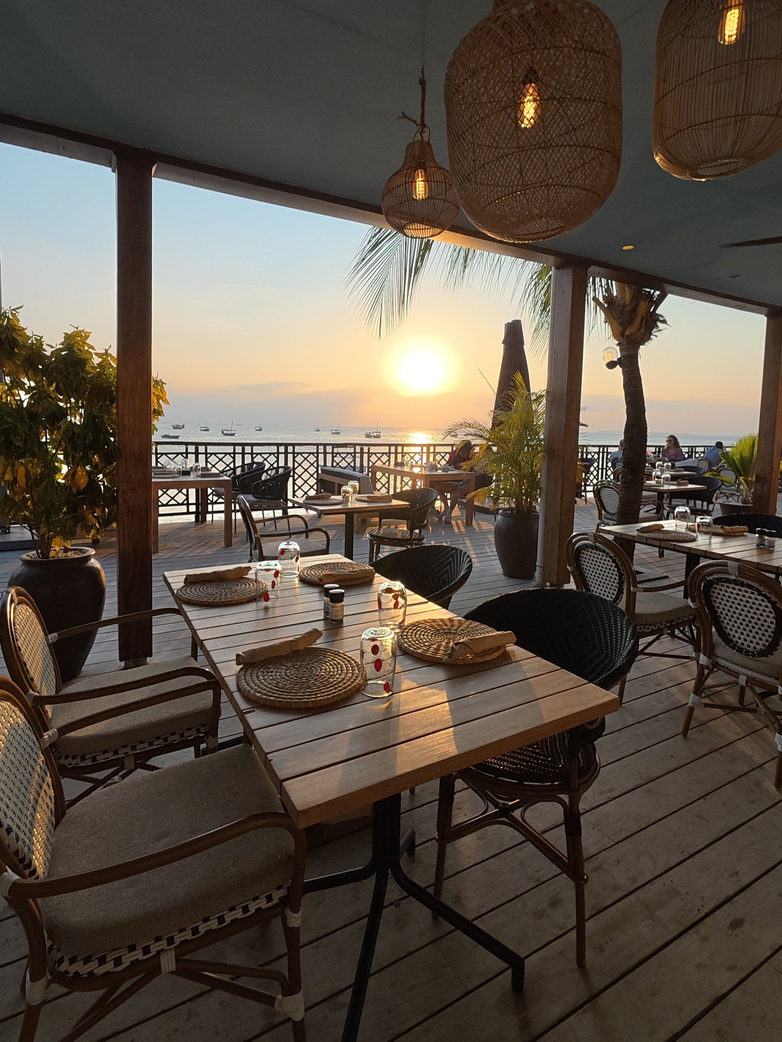 Beach House Zanzibar restaurant tables at sunset overlooking the Stone Town waterfront
