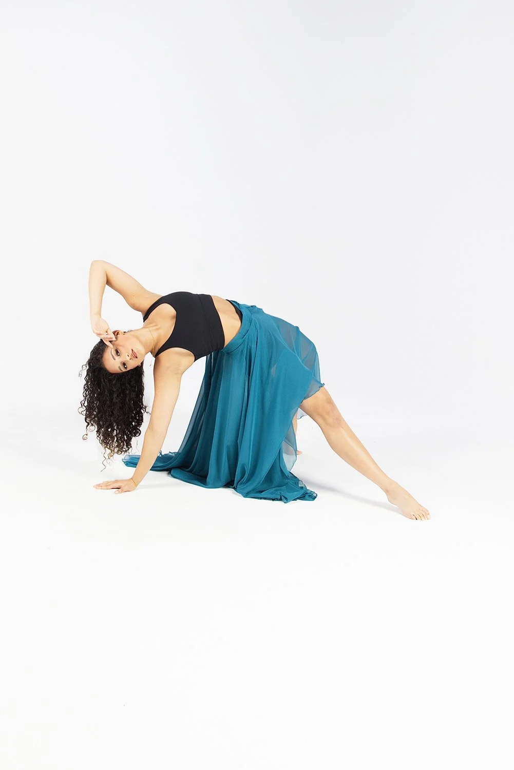 Dancer bending back with green skirt