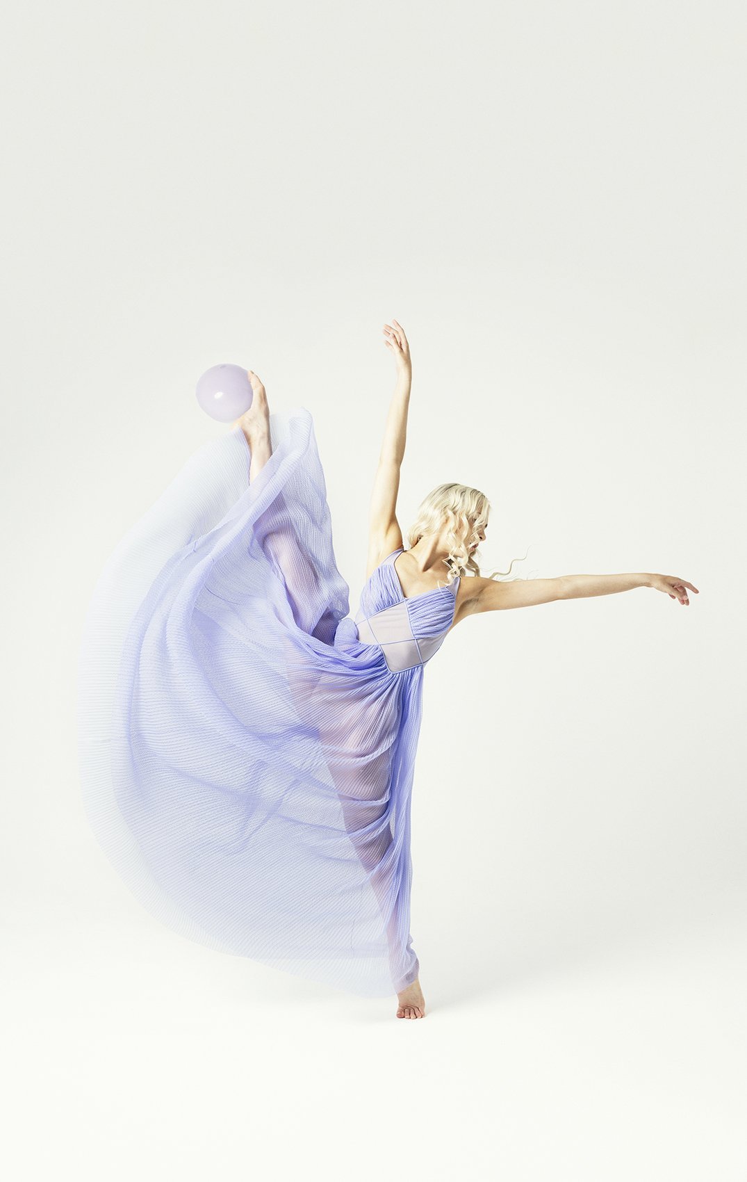 Woman with leg and arm touching in the air during Motion Dance Portrait Session with Beauclair Photography