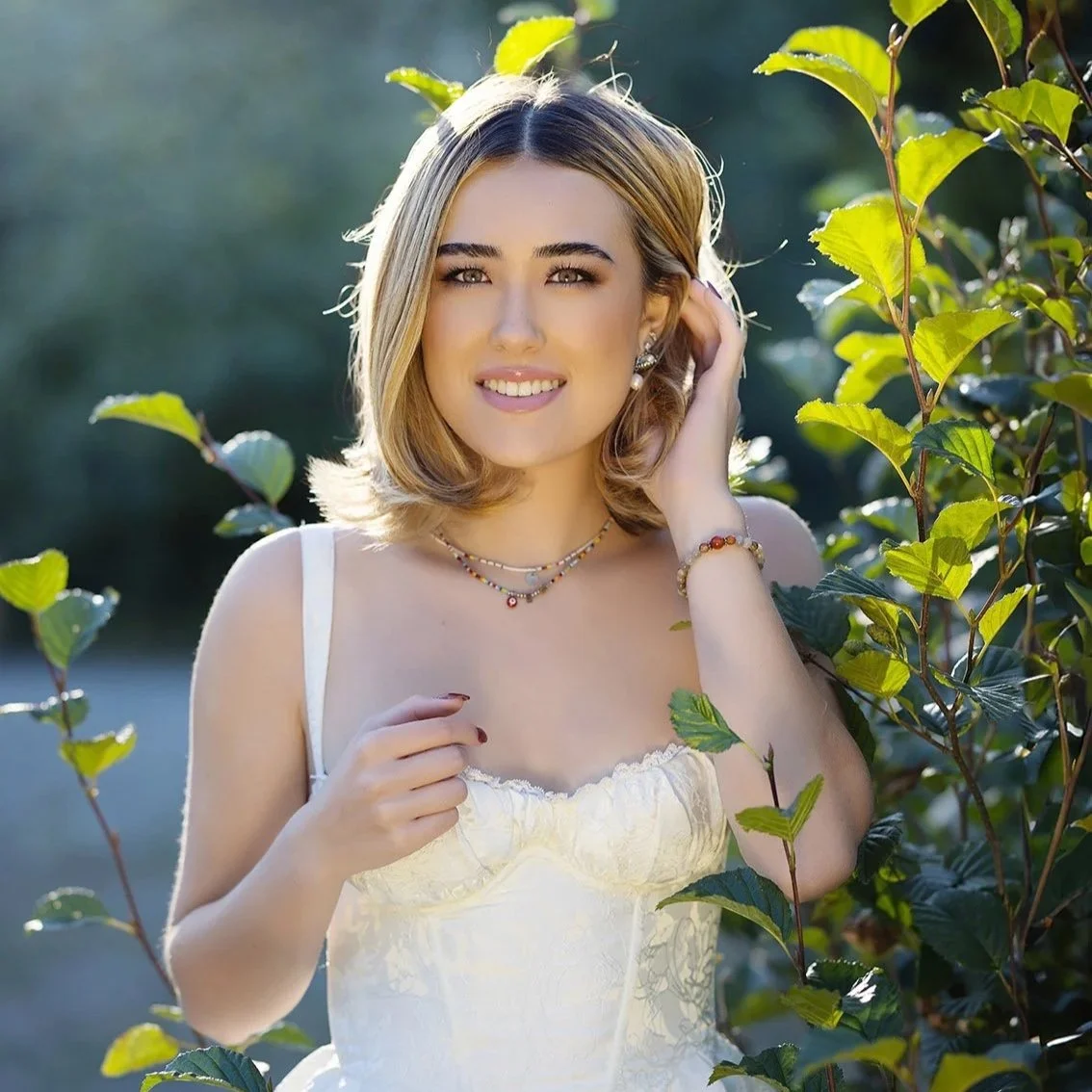 senior portrait photographer near me in bellevue Washington senior with white dress and backlit hair at gold creek pond on Snoqualmie Pass by Beauclair Photography