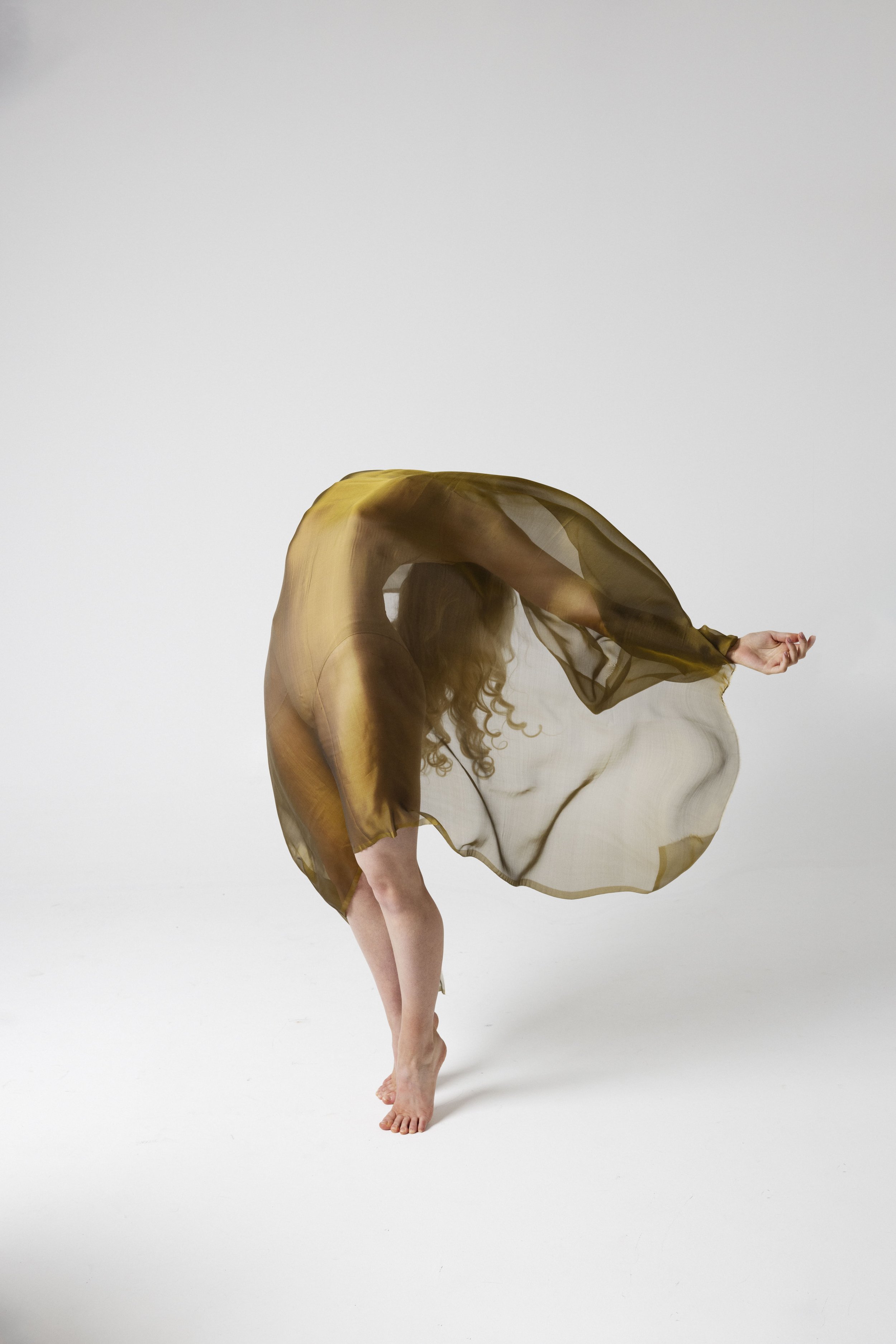 Woman leaning back with gold fabric during Motion Dance Portrait Session with Beauclair Photography