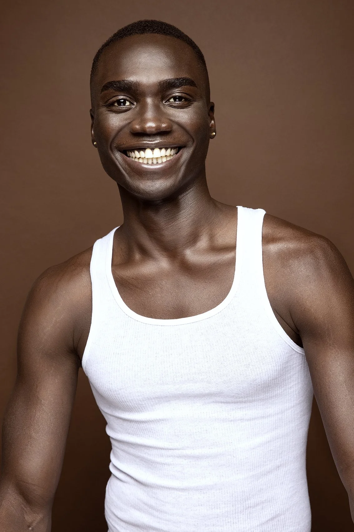 headshot of black man in white tank top for modeling and acting