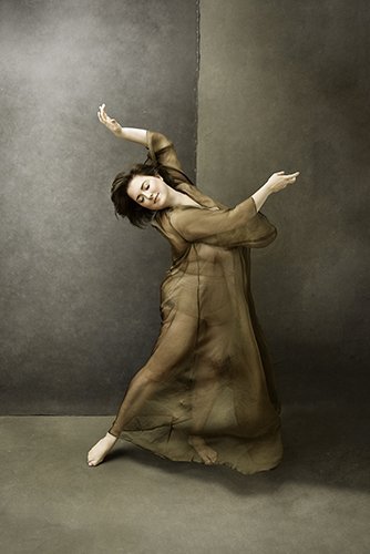 Woman dancing with arms in the air during Motion Dance Portrait Session with Beauclair Photography