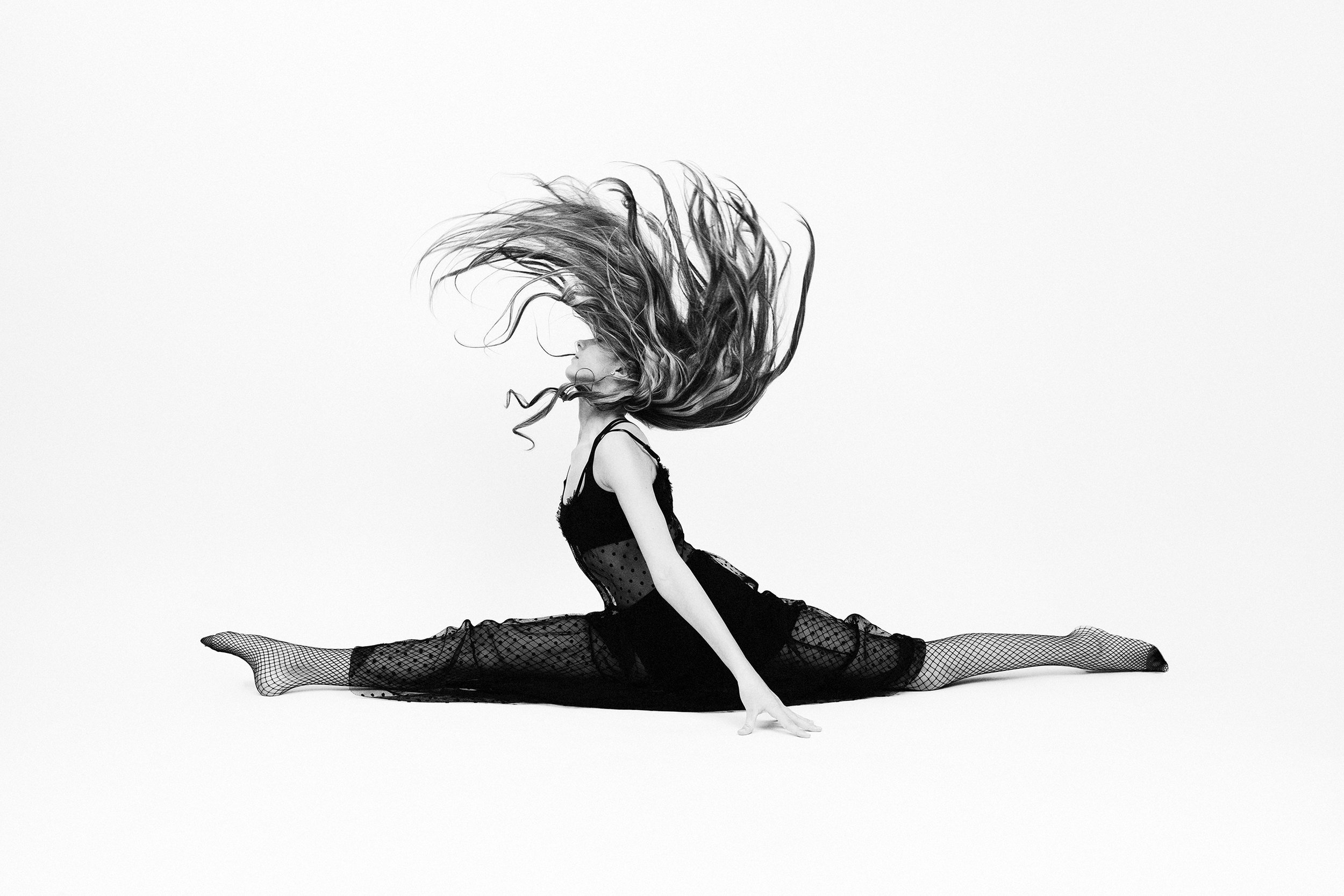 Woman performing a split mid air during Motion Dance Portrait Session with Beauclair Photography