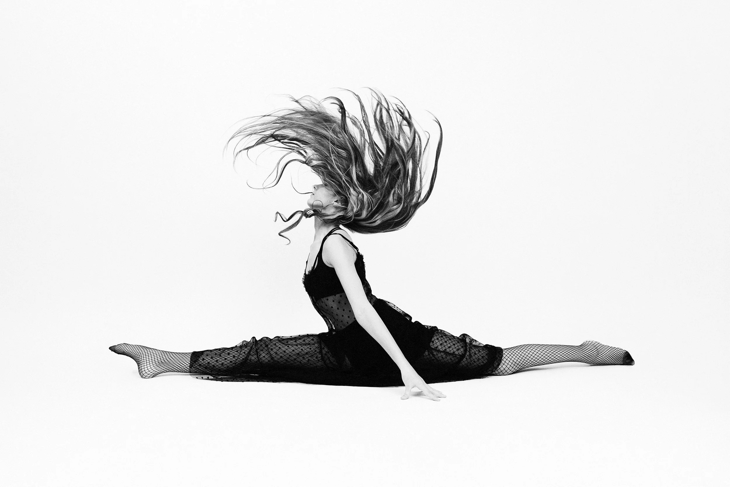 Woman performing a split mid air during Motion Dance Portrait Session with Beauclair Photography