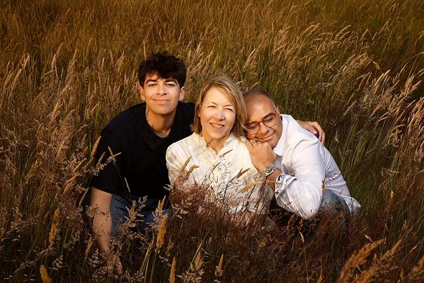 Discovery Park in seattle for family portraits by Beauclair Photography.  Family of 3 at Golden Hour in tall grass.