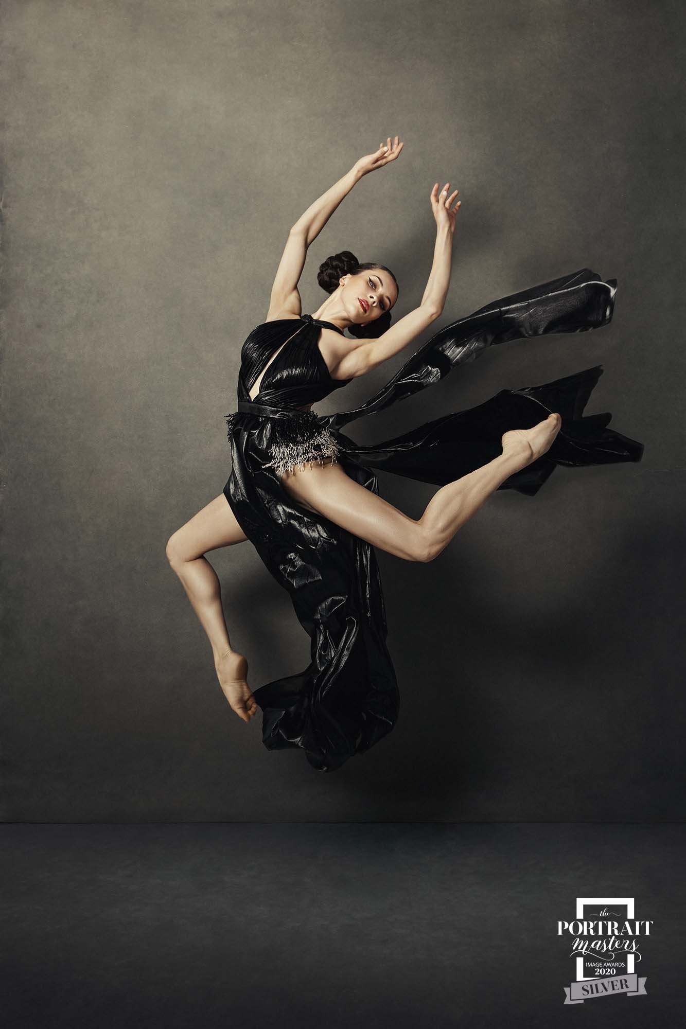 Woman jumping in the air flailing fabric during Motion Dance Portrait Session with Beauclair Photography