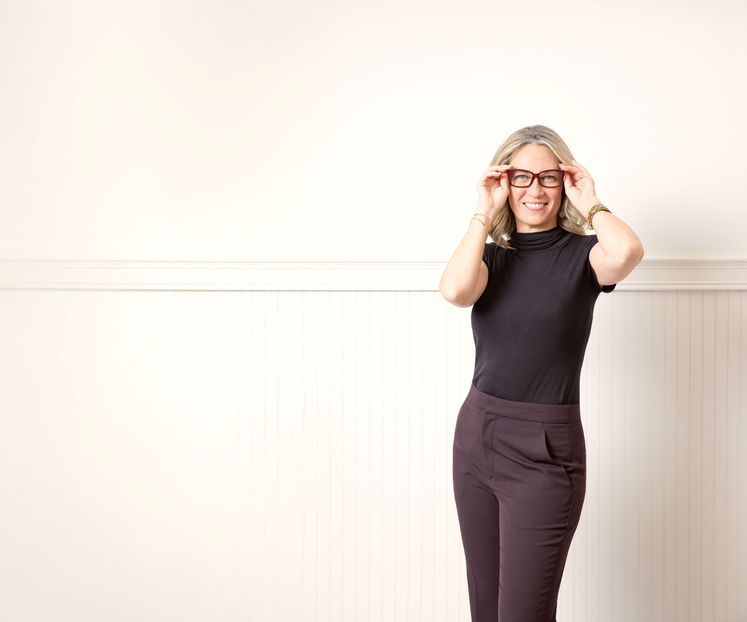 kirkland author in white studio posing for branding session