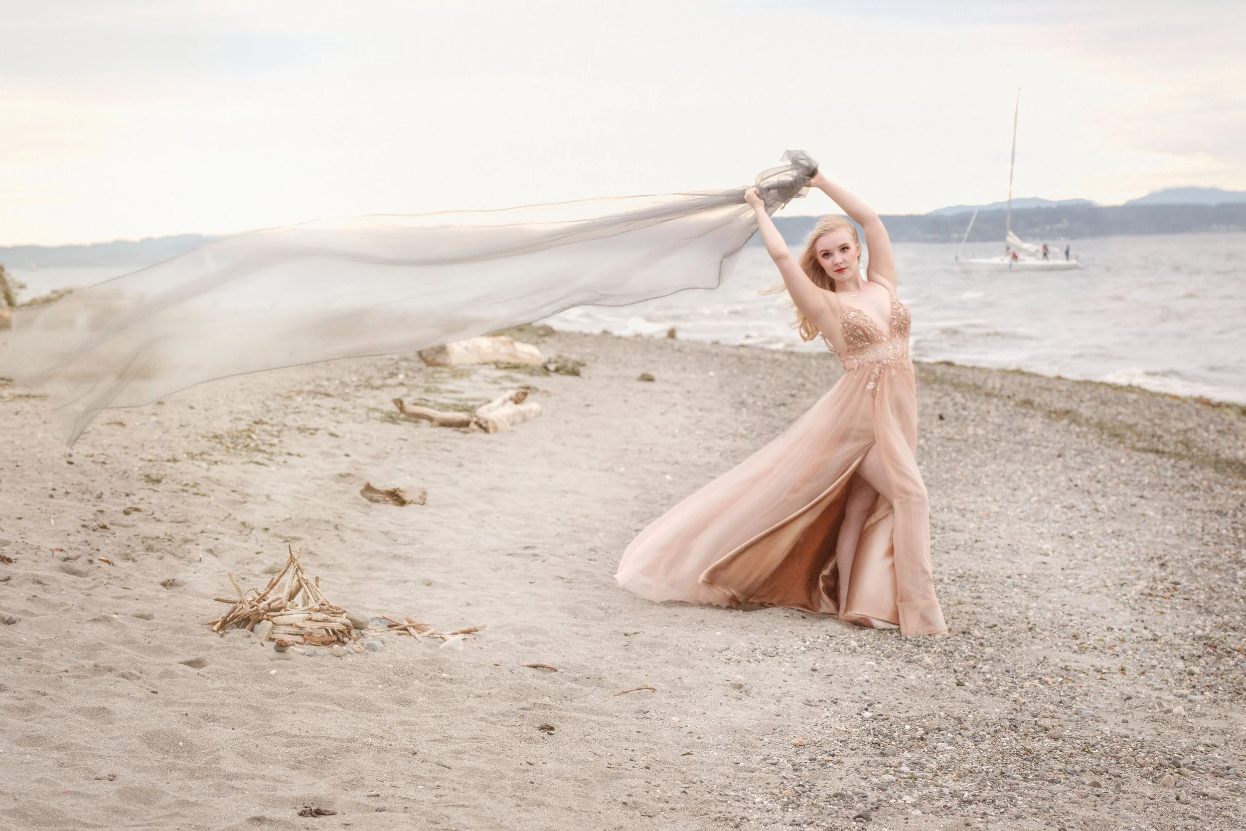 Seattle senior portraits in Golden Gardens park in seattle wa.  Kirkland senior portrait photographer, Beauclair Photography, near me of girl in prom dress with sailboat in background