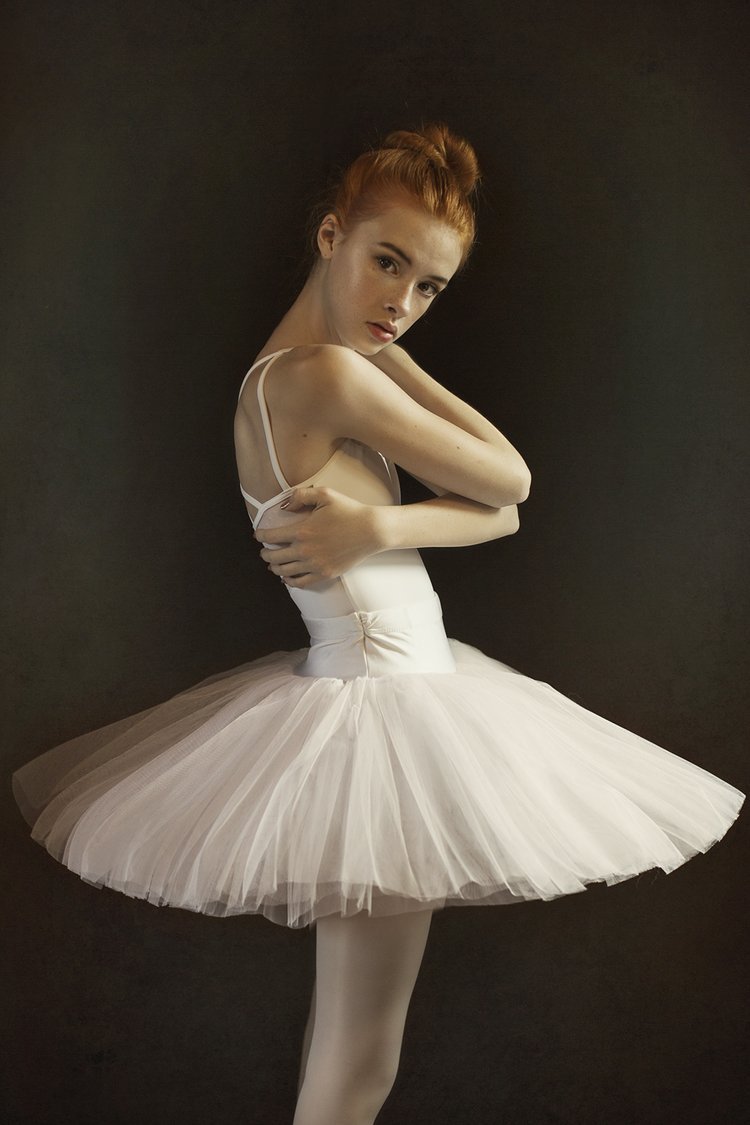 Woman in tutu holding herself during Dance Photo Session with Beauclair Photography