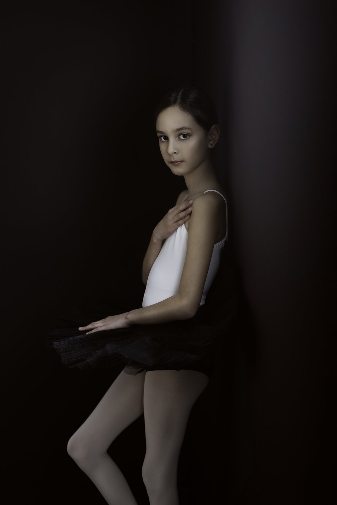 Woman in tutu leaning against a wall during Dance Photo Session with Beauclair Photography