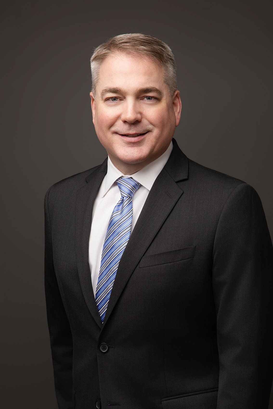 Seattle headshots photographer and personal branding expert photos of professionals for linkedin and other use cases. Man wearing a suite for his corporate headshot in Bellevue.