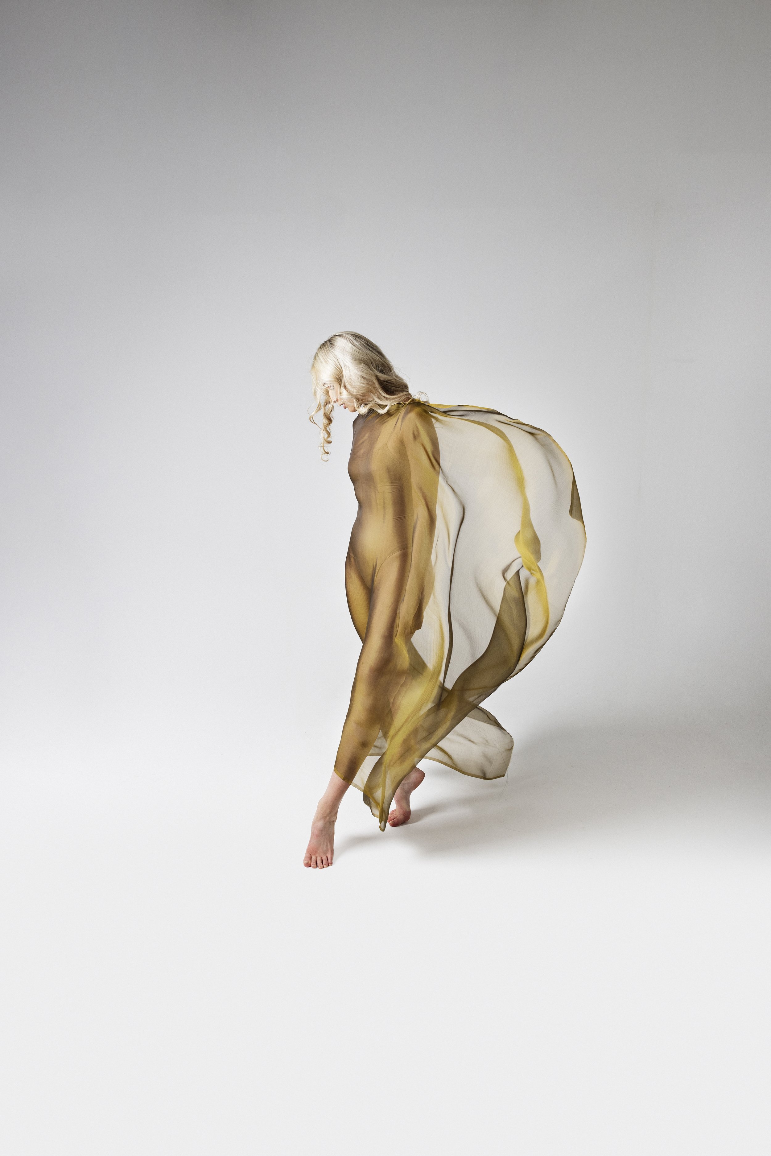 Woman with fabric flowing behind her during Motion Dance Portrait Session with Beauclair Photography