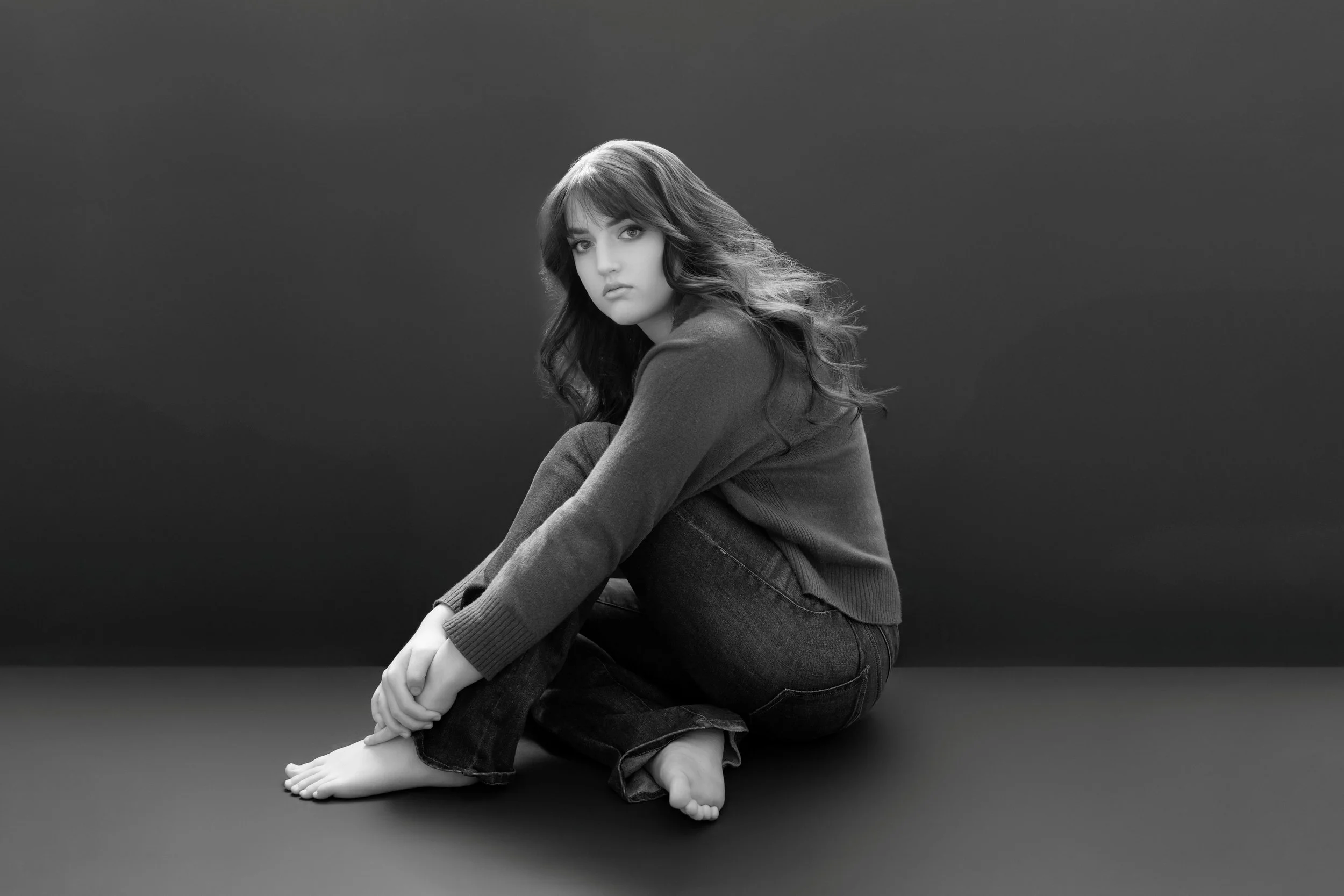 Black and white studio senior portrait of a girl, photographed by Beauclair Photography in Kirkland WA