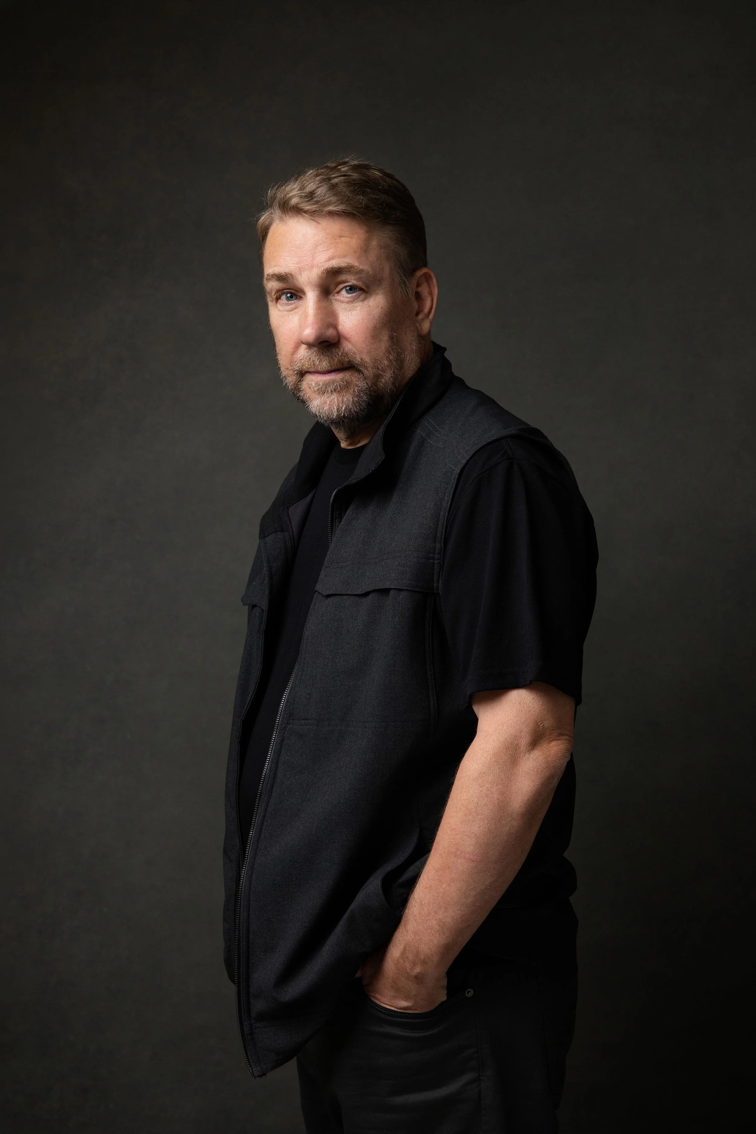 Seattle author poses in a dark Kirkland studio for headshot